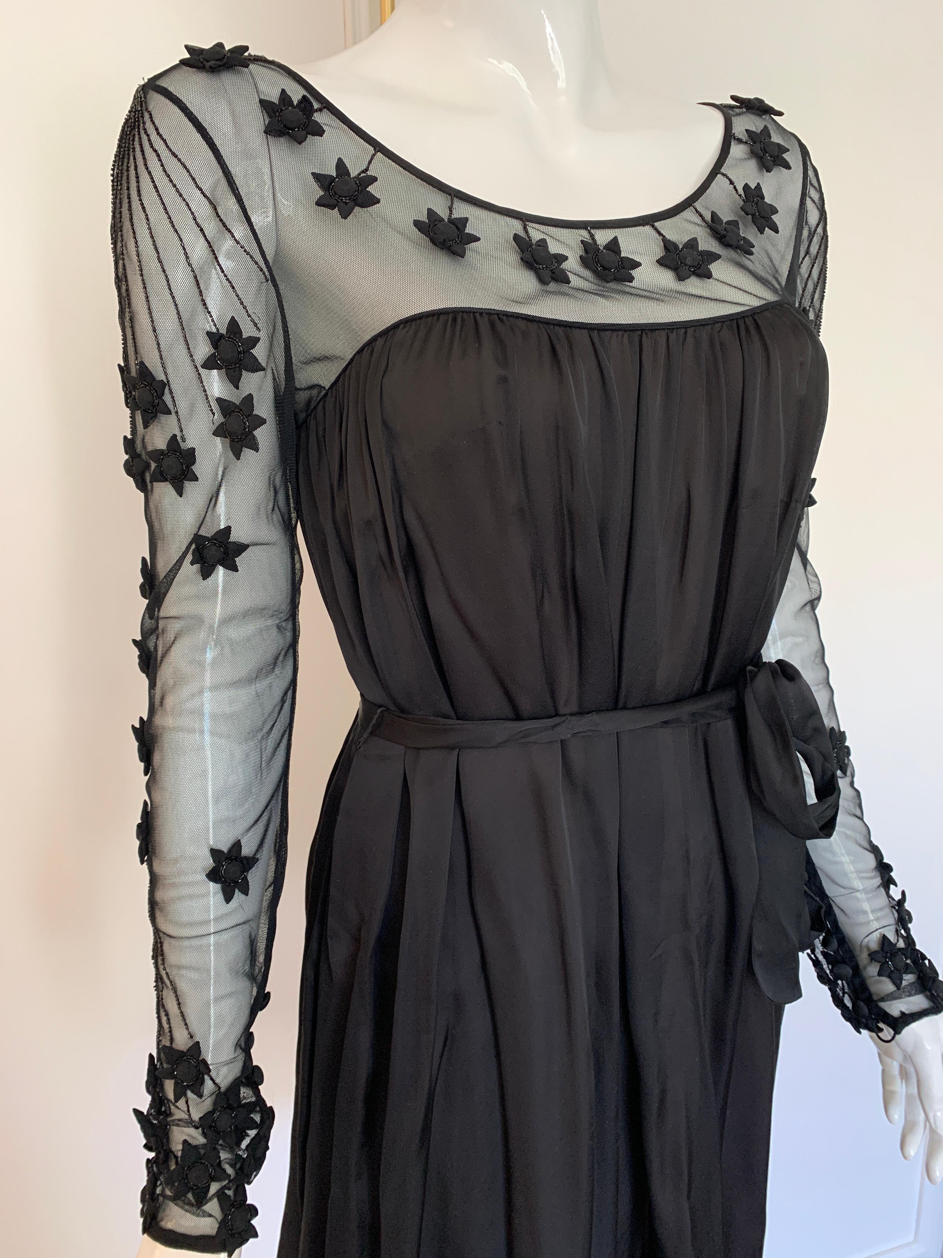 Temperley Black Flower Applique Silk Dress in size Ex small/small. 
100% Silk with a lining of nude silk. 
Sheer arms and neck detailing. 
Some imperfections with applique, please see photos. 
Mid Length with a belt. 

