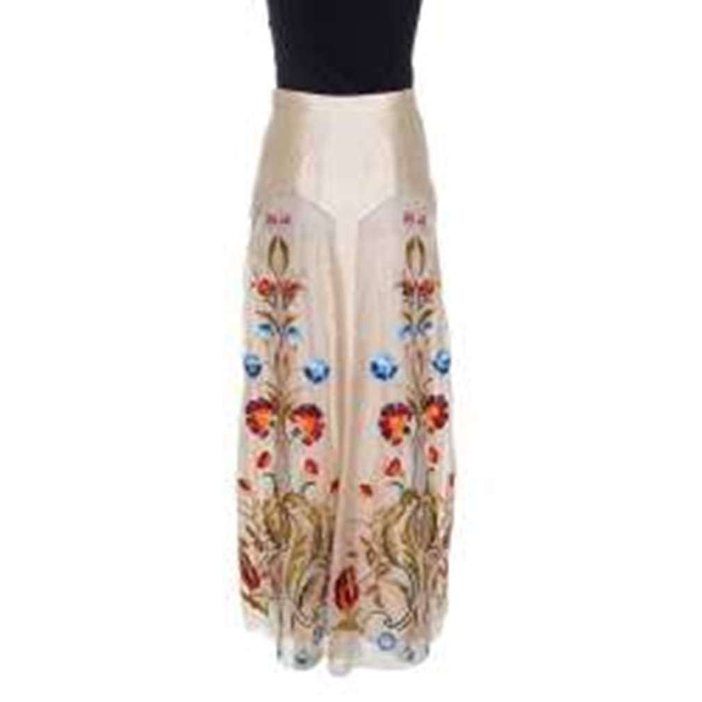 Become the trendsetter with this exclusive skirt designed by Temperley London. Flaunt your exceptional dressing sense with this beautiful beige skirt styled in a maxi length and adorned with a lovely floral embroidery all over. This silk skirt is