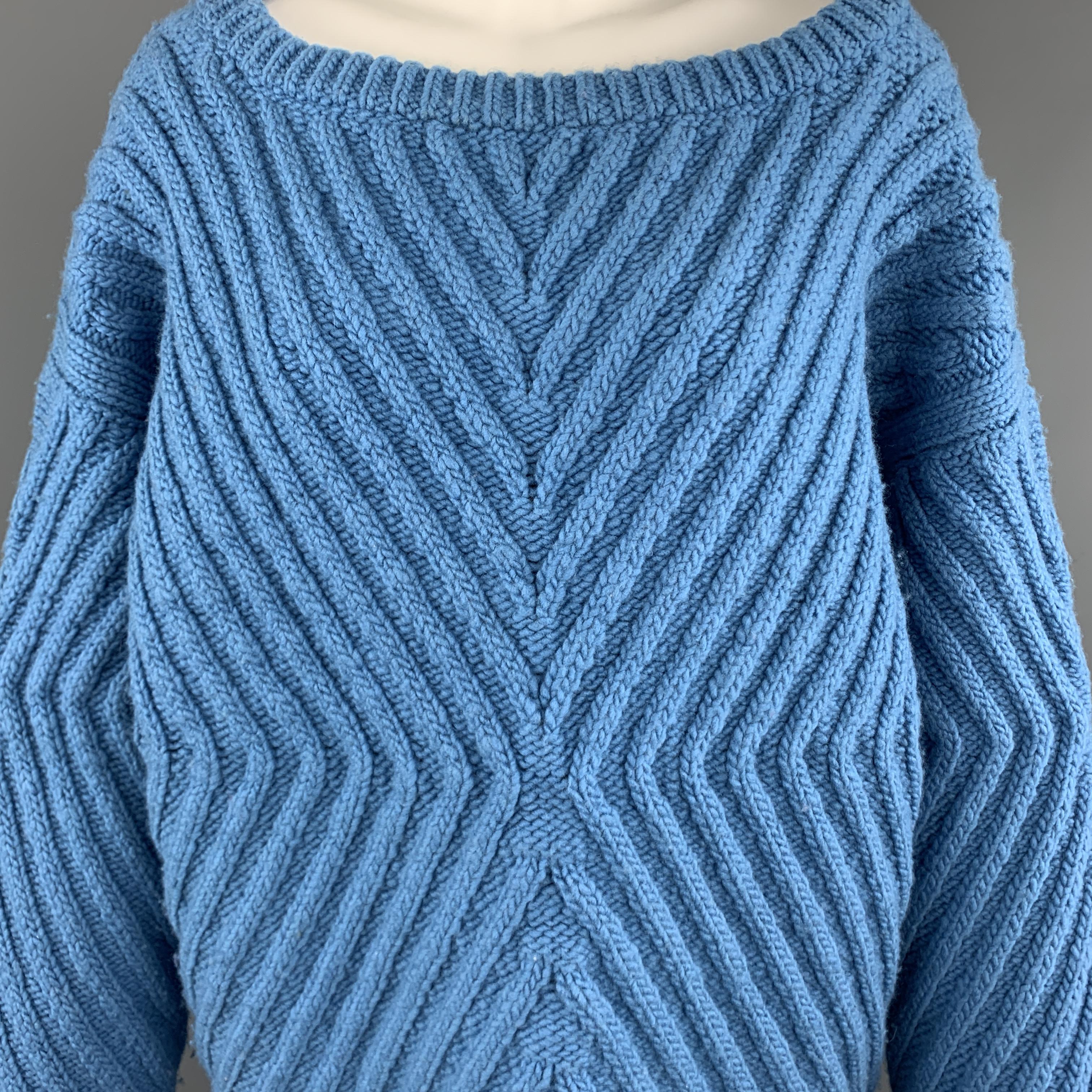 TEMPEST + BENTLEY sweater comes in blue blue chunky wool knit with a ribben X pattern throughout, boat neck, and oversized silhouette. Made in USA.

Very Good Pre-Owned Condition.
Marked: S

Measurements:

Shoulder: 24 in.
Bust: 46 in.
Sleeve: 23