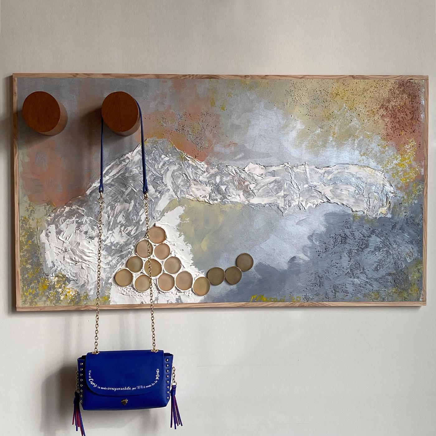 Created by Mascia Meccani in 2020, this stupendous work of art combines a mixed-media wooden decorative panel with a fine cherry wood wall hanger composed of two sleek and practical cylinders. Entirely crafted and painted by hand, it features a