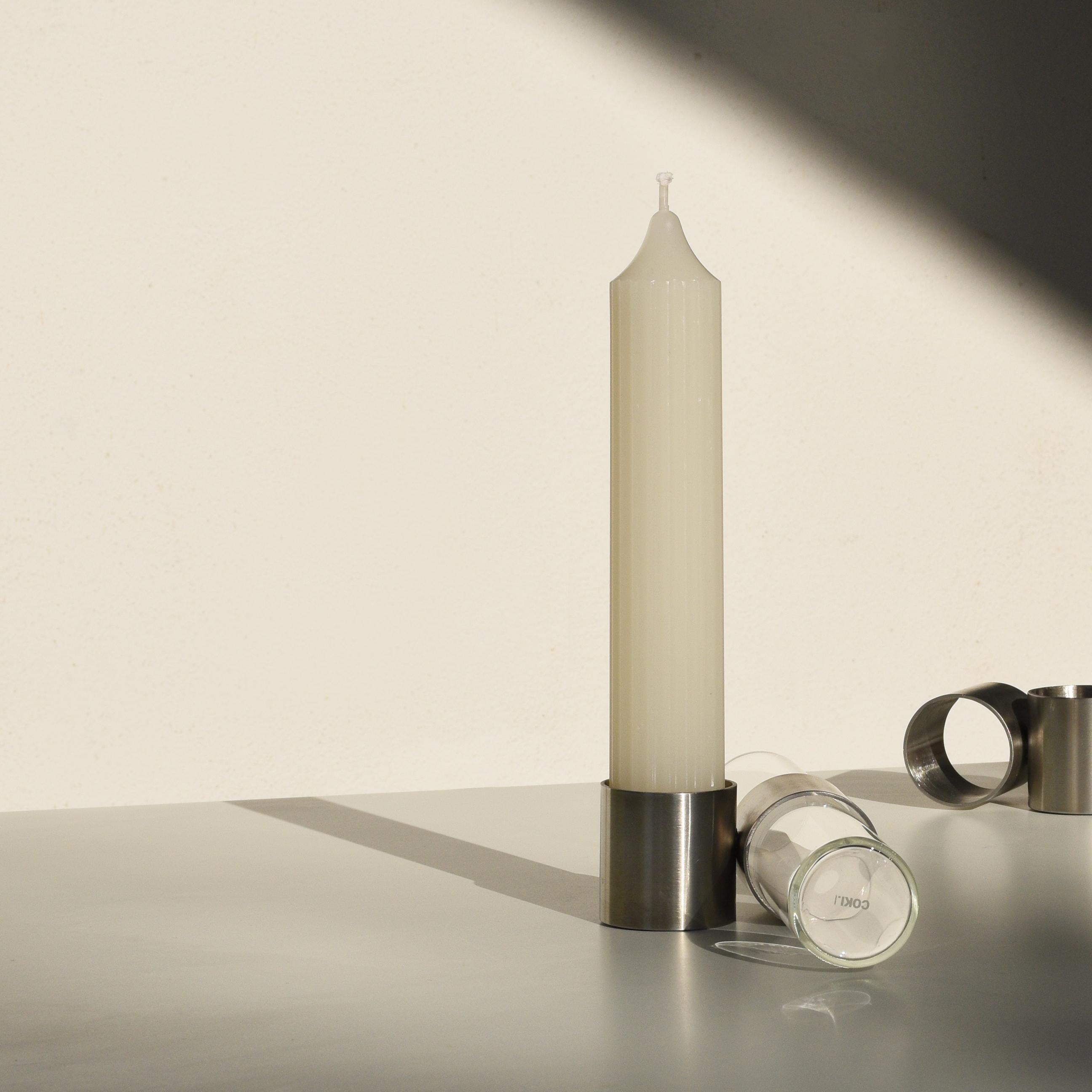 Candle holder and flower vase in a single object, Tempio del Tempo was conceived as a small altar for the home, created through the union of simple and symbolic shapes that fit together without connections and remain divisible: two stainless steel