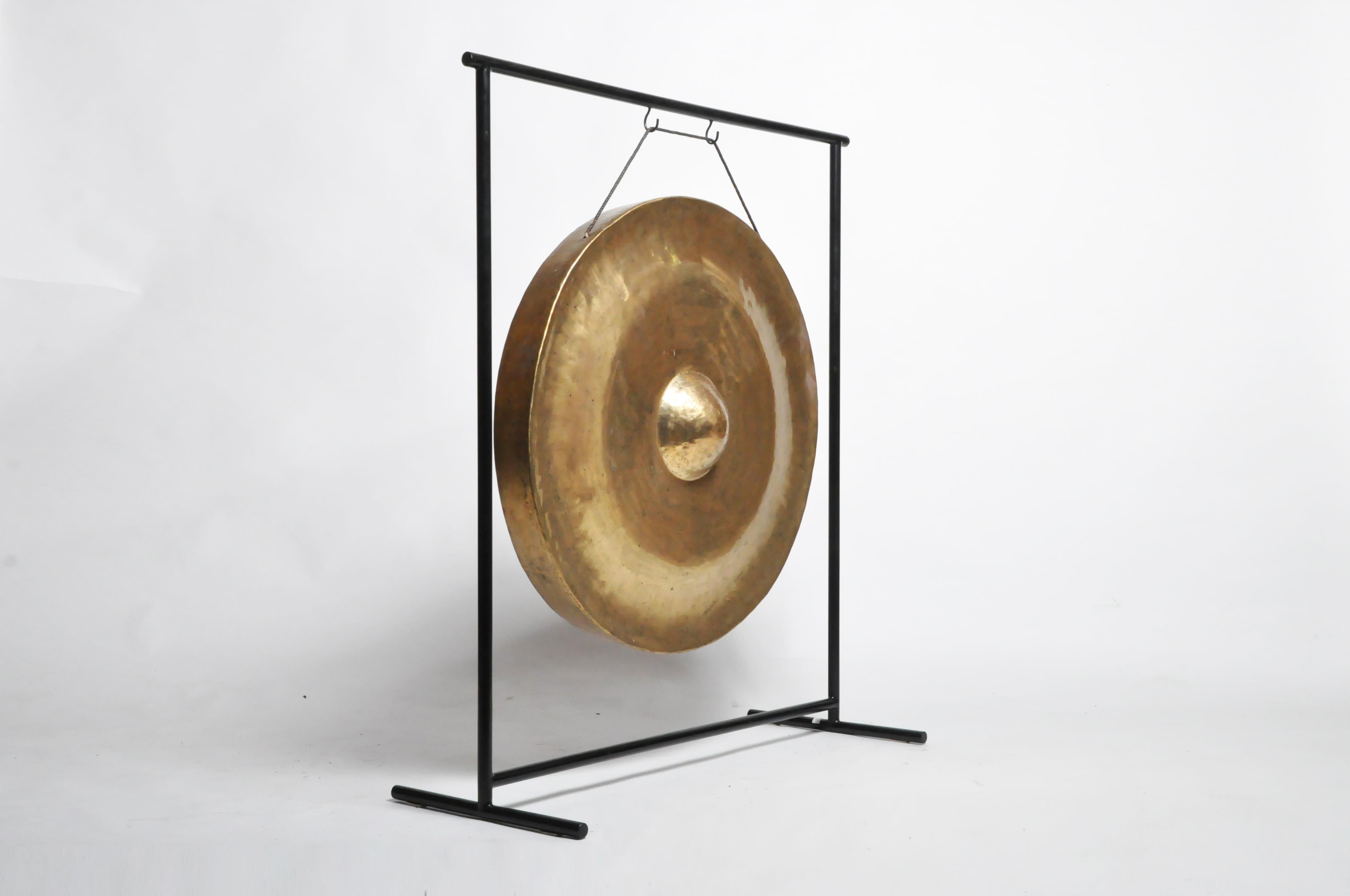 This brass gong was once given to a temple to gain merit for the giver. According to Buddhist belief, meritorious gifts help one achieve a higher reincarnation. So many gongs are given to temples that monks often trade them for other articles. This