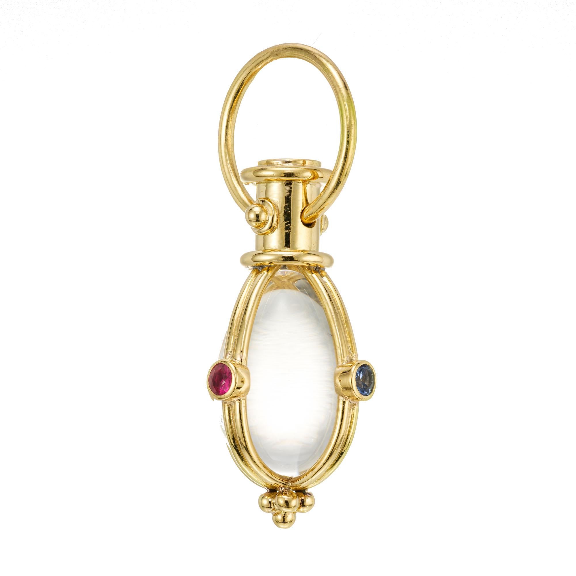 Temple St. Clair Amulet gemstone pendant. Pear quartz crystal set in 18k gold with round ruby, emerald and sapphire accent stones. 

1 pear cabochon clear rock crystal quartz
2 round red rubies, approx. .20cts
1 round green emerald, approx. .7cts
1