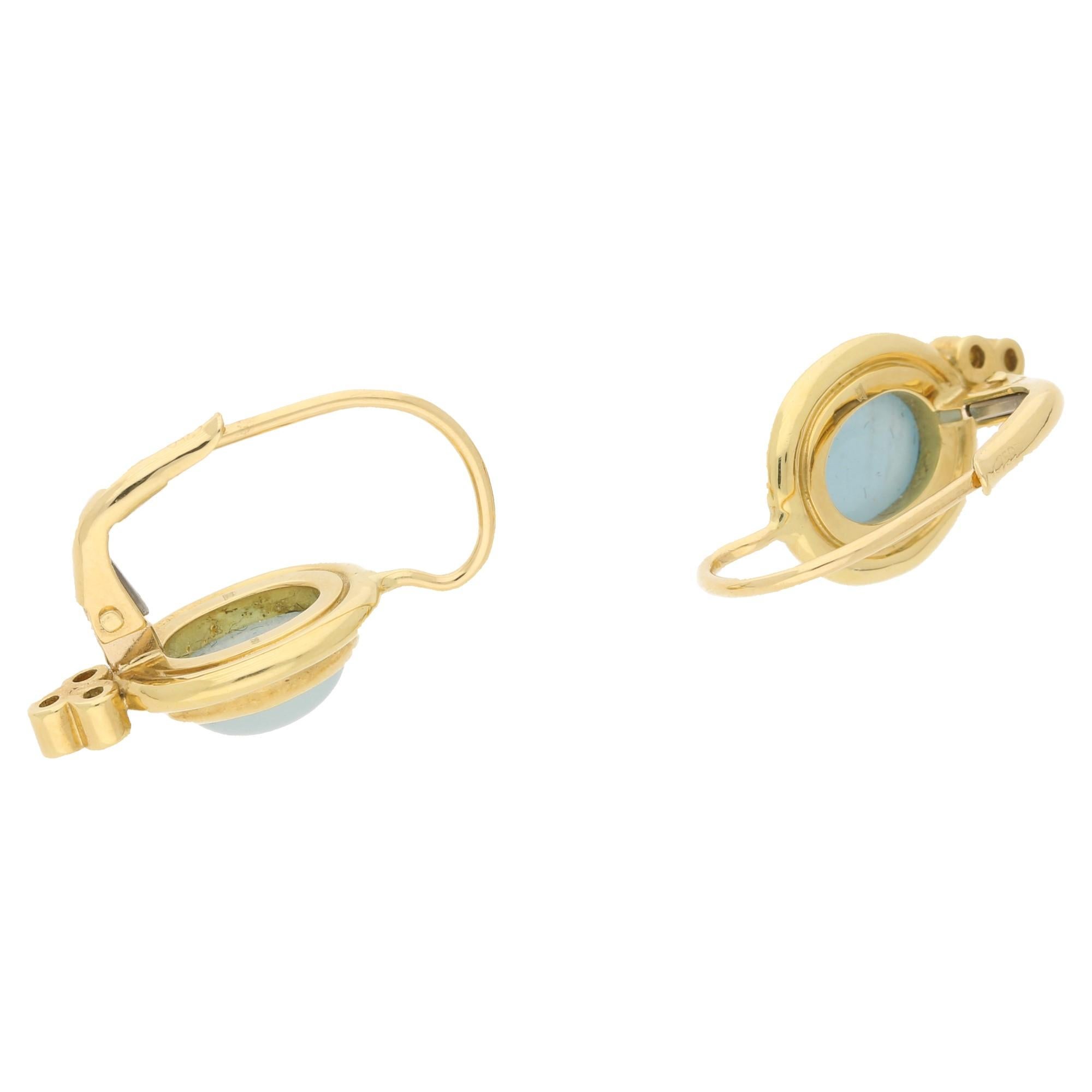 Temple St Clair classical aquamarine cabochon and diamonds drop earring in 18ct yellow gold with lever back fittings, featuring a central 8mm oval aquamarine cabochon rubover set in a border surround with three round brilliant cut diamonds rubover