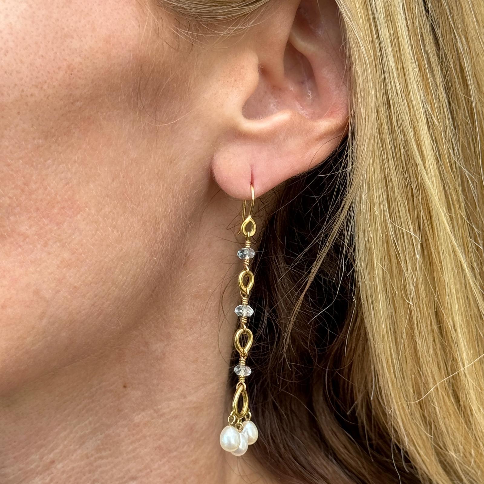 These stunning Temple St. Clair earrings feature lustrous cultured pearls paired with vibrant blue briolette gemstones, elegantly suspended from 18K yellow gold settings. Measuring approximately 2.5 inches in length, the dangle design adds graceful