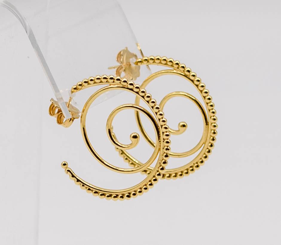 You can count on Temple St Clair to offer the wearable and dependable - but always, always with her unique, chic twist.   In these earrings, she offers a simple rounded wire hoop through the earlobe, but she then embellishes it with Archimedean