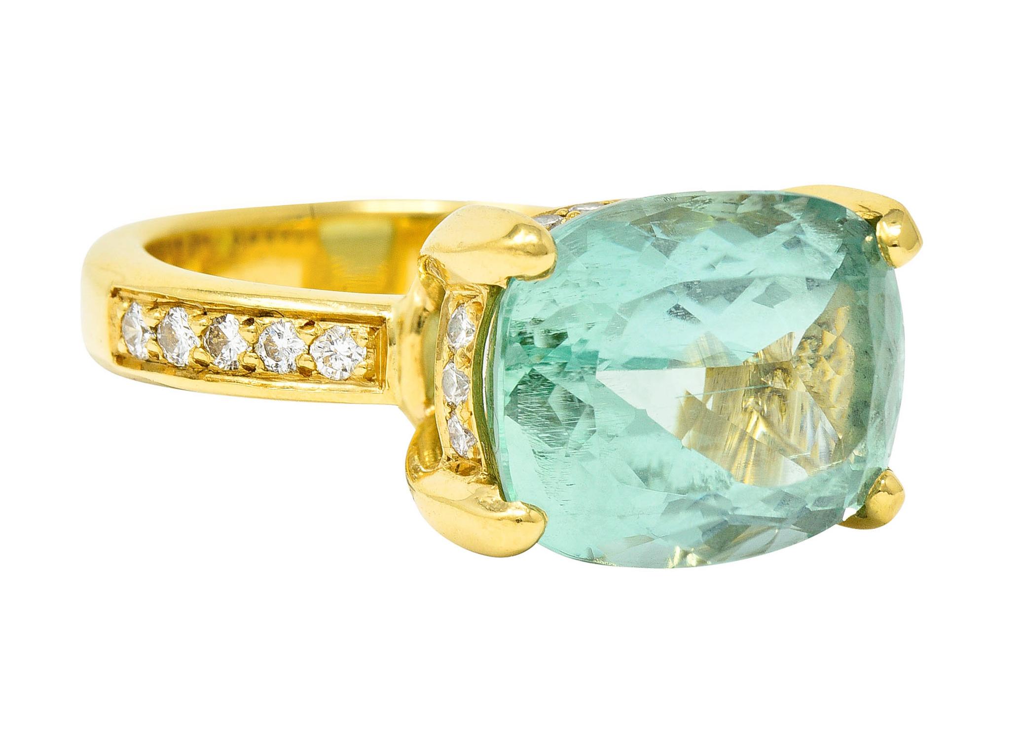 Featuring a mixed cushion cut beryl measuring approximately 15.0 x 11.5 mm

Transparent and uniform in medium light strongly bluish green color

Basket set by wide prongs with round brilliant cut diamond accents throughout

Weighing in total