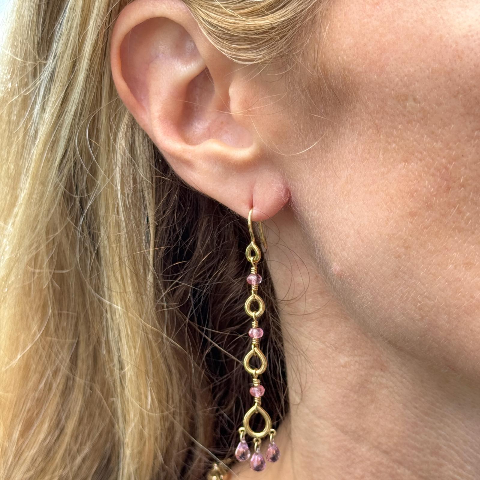 These elegant Temple St. Clair earrings feature delicate pink topaz briolette gemstones suspended from classic hook settings, creating graceful movement and eye-catching sparkle. Measuring approximately 2.5 inches in length, the dangle design adds a
