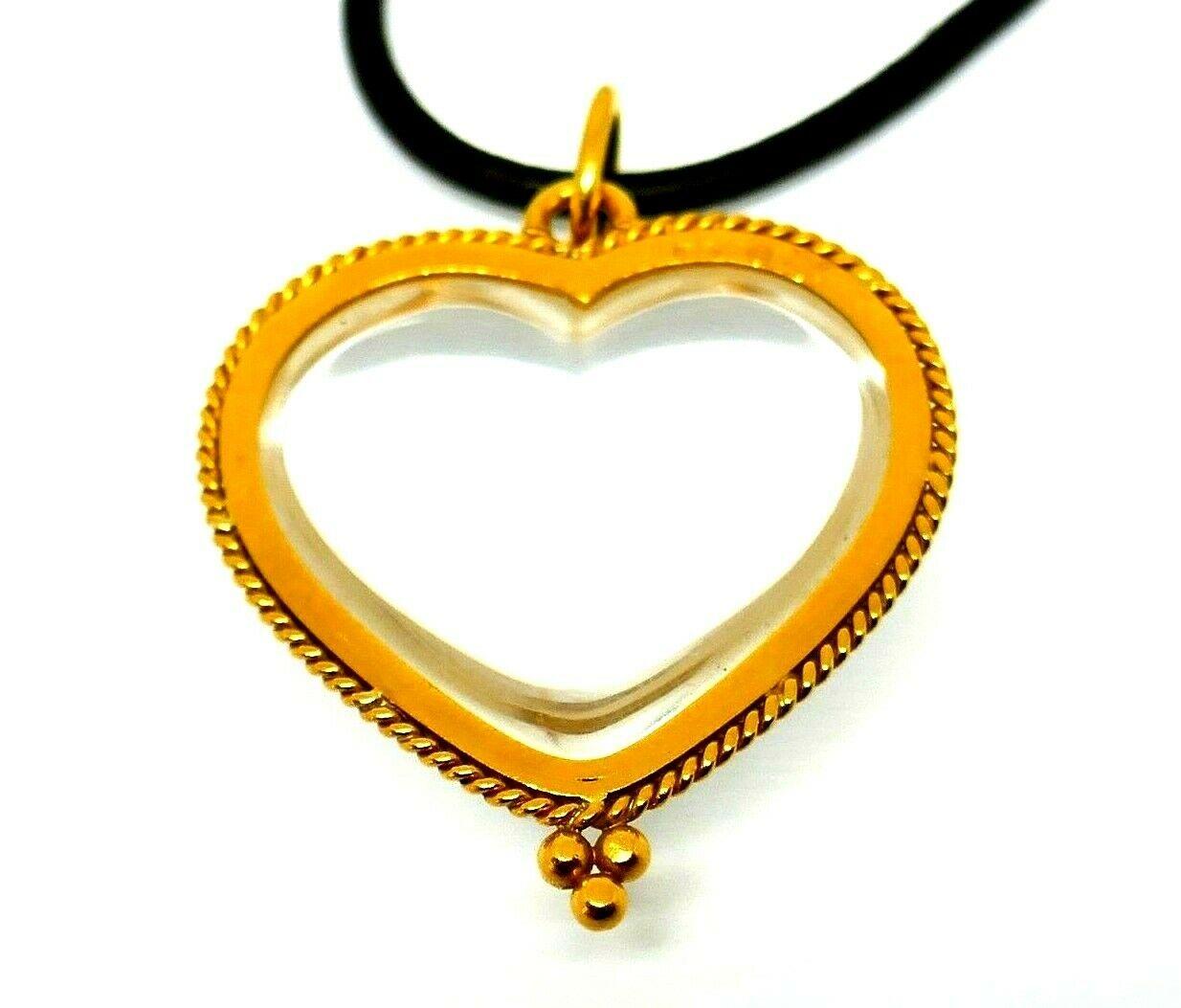 Leather cord necklace featuring a heart-shaped pendant, all by Temple St. Clair. The natural rock crystal heart is sitting in a braided 18k yellow gold frame. The color of the gold gives this piece a nice vintage touch. 
Stamped with the Temple St.