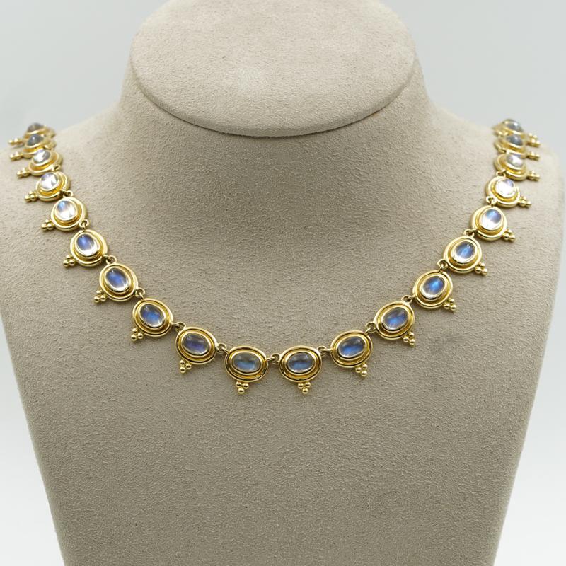 The 18K Classic Temple Necklace from Temple St. Claire finds a suite of luminous blue moonstones set in Temple Saint Claire's signature yellow gold. It features the brand's iconic trio motif and is finished with the Temple charm. The clasp and chain