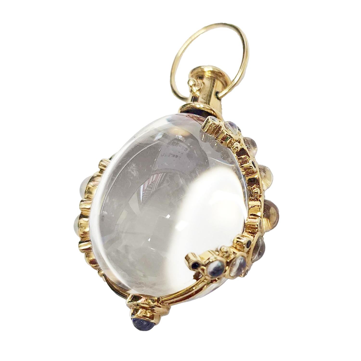 18K ORIGINAL ROCK CRYSTAL AMULET
Temple St'Clair neckpiece finds elegance in its tailored simplicity. Here, delicate golden bands cradle a finely polished rock crystal ball shaped like an egg. The 18K gold frame is set with moonstones, white