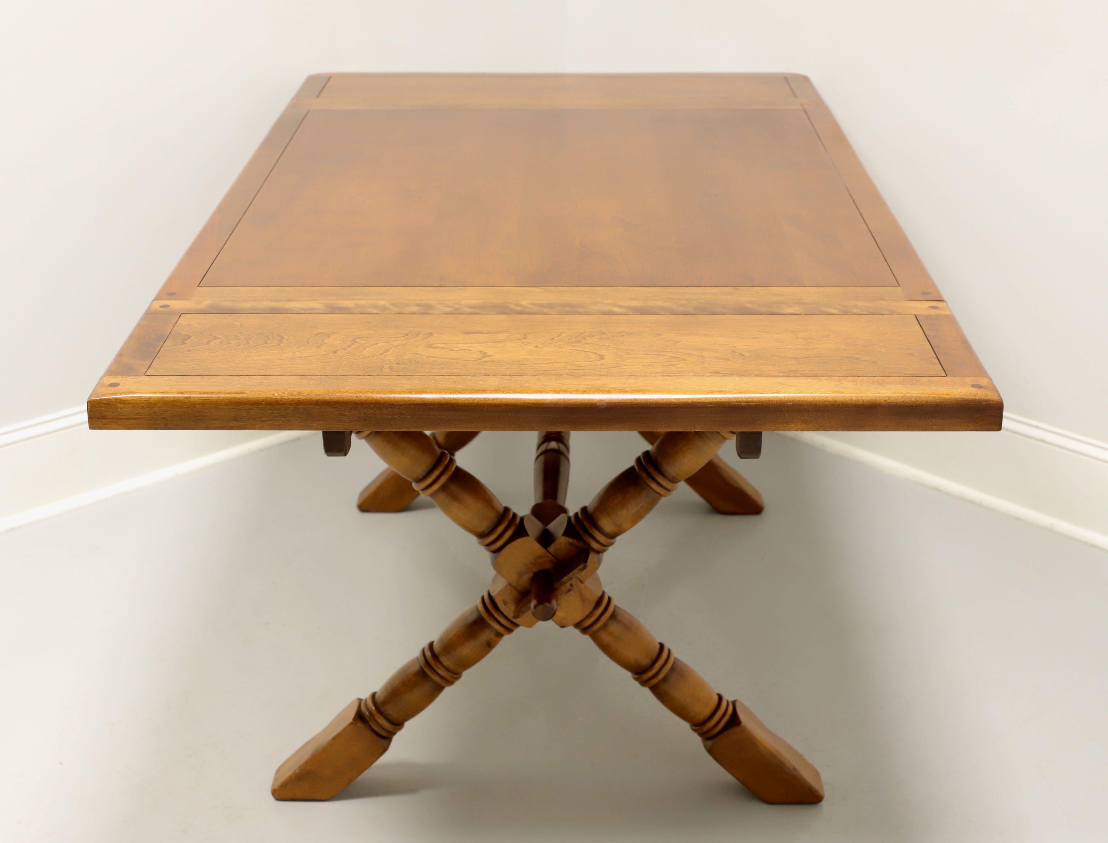 A Farmhouse style dining table by Temple Stuart, their Rockingham. Maple & birch, thick banded top with decorative pegs at corners, solid apron, turned 