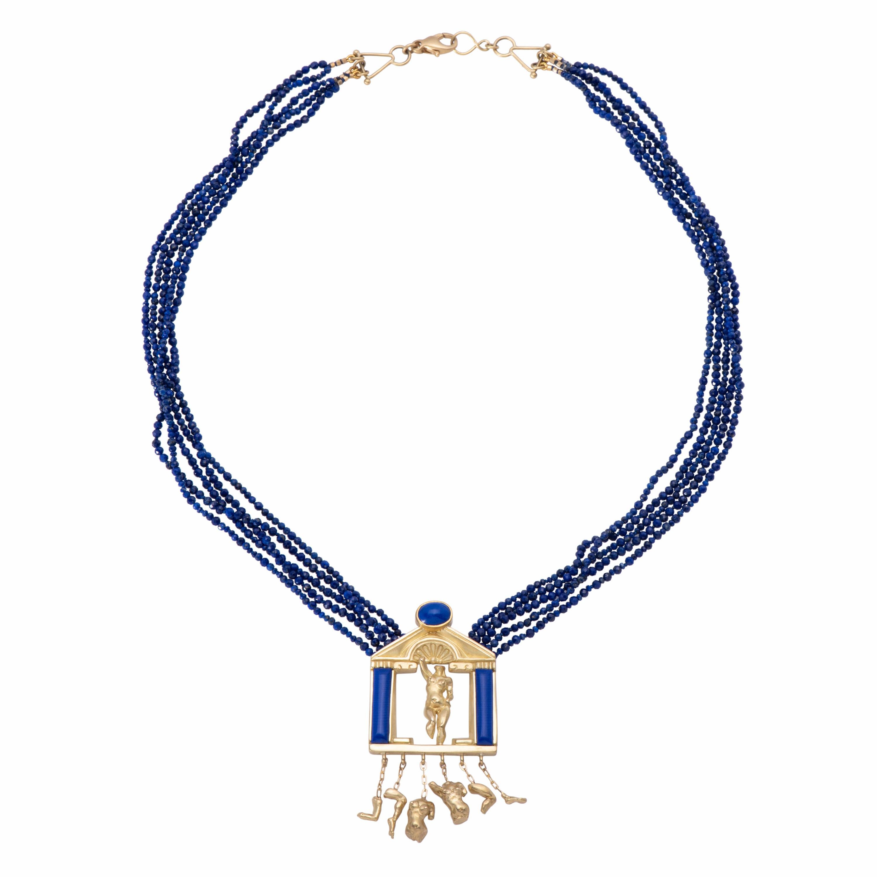 Temple to Venus Pendant is an ode to the goddess in 18k gold and blue lapis. A classic Roman temple in gold displays a statuary Venus, one arm raised and a knee lifted in movement. Below, broken pieces of classic Roman statuary dangle from gold