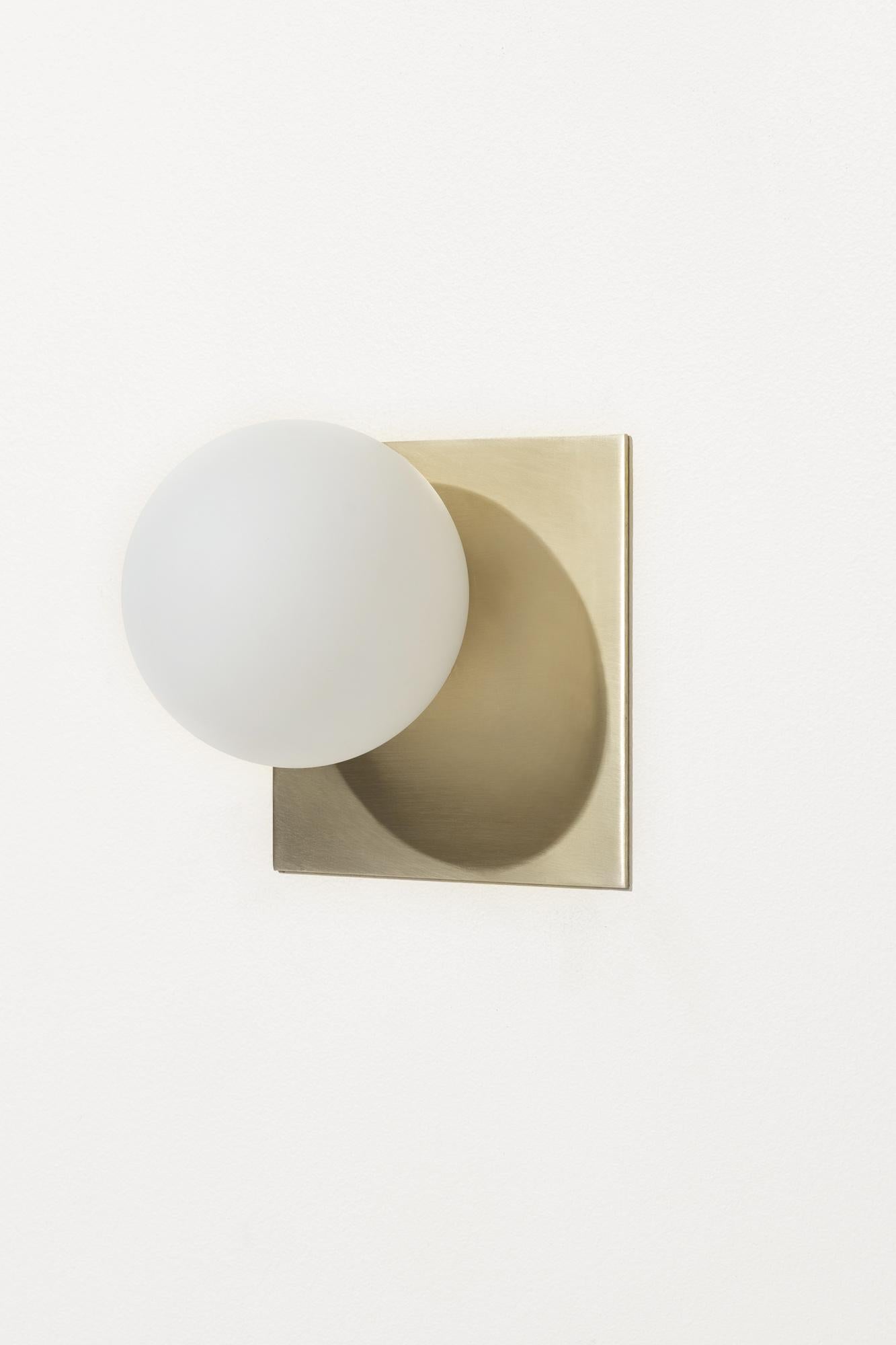 The Tempo flush mount is made with a satin brass or matte black backplate and handblown opal white sandblasted glass. Also available as a wall sconce.

5 1/4 in (13 cm) W x 4 in (10 cm) D x 5 1/4 in (13 cm) H

1 x G8 socket
G8 LED bulbs