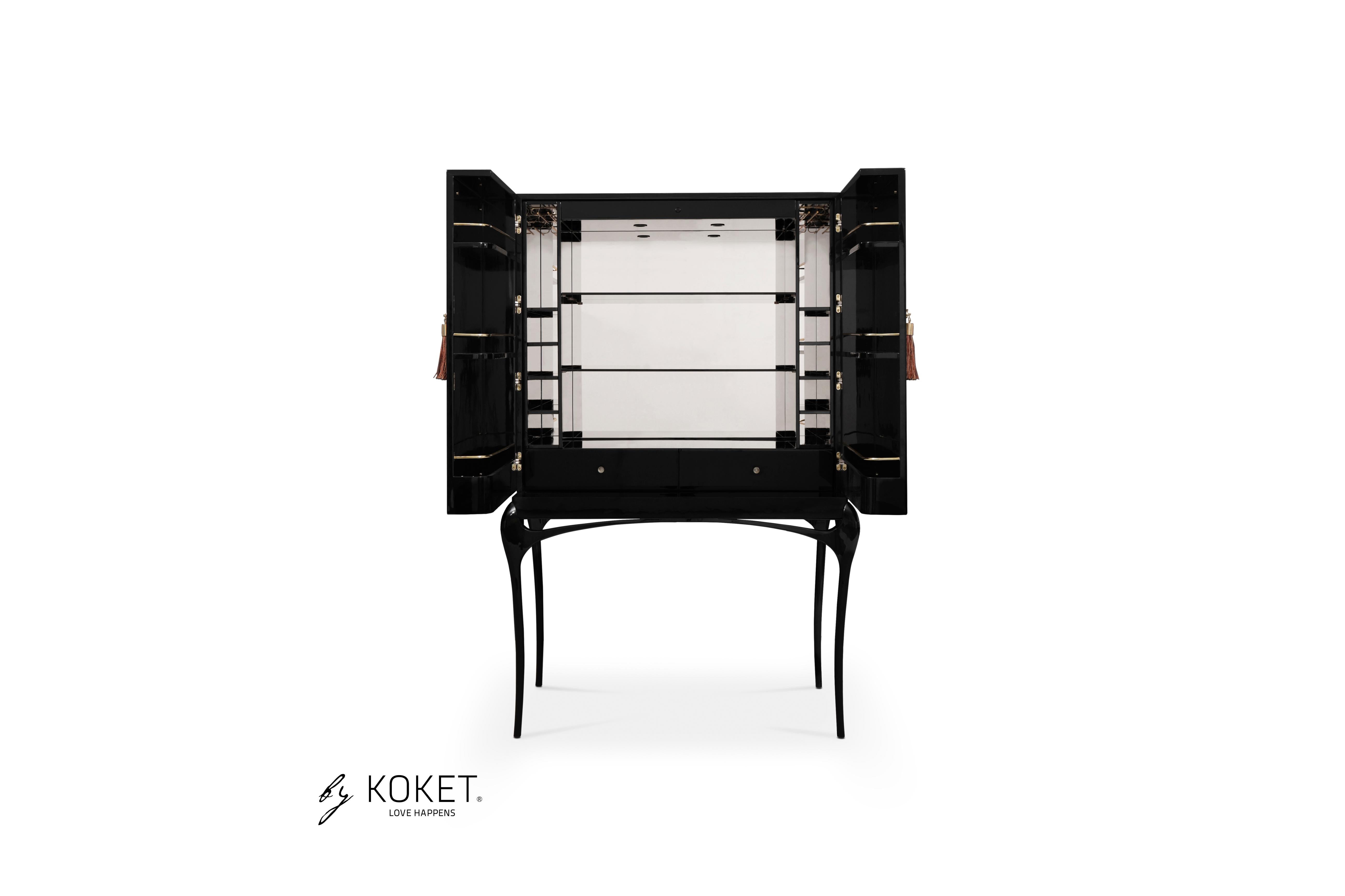 Enticing admirers with its exotic feather doors and sexy curved lacquered legs, the temptation bar cabinet will steal cocktail hour. The chic black and gold interior is perfectly designed to store your wine and cocktail accoutrements. Open or closed