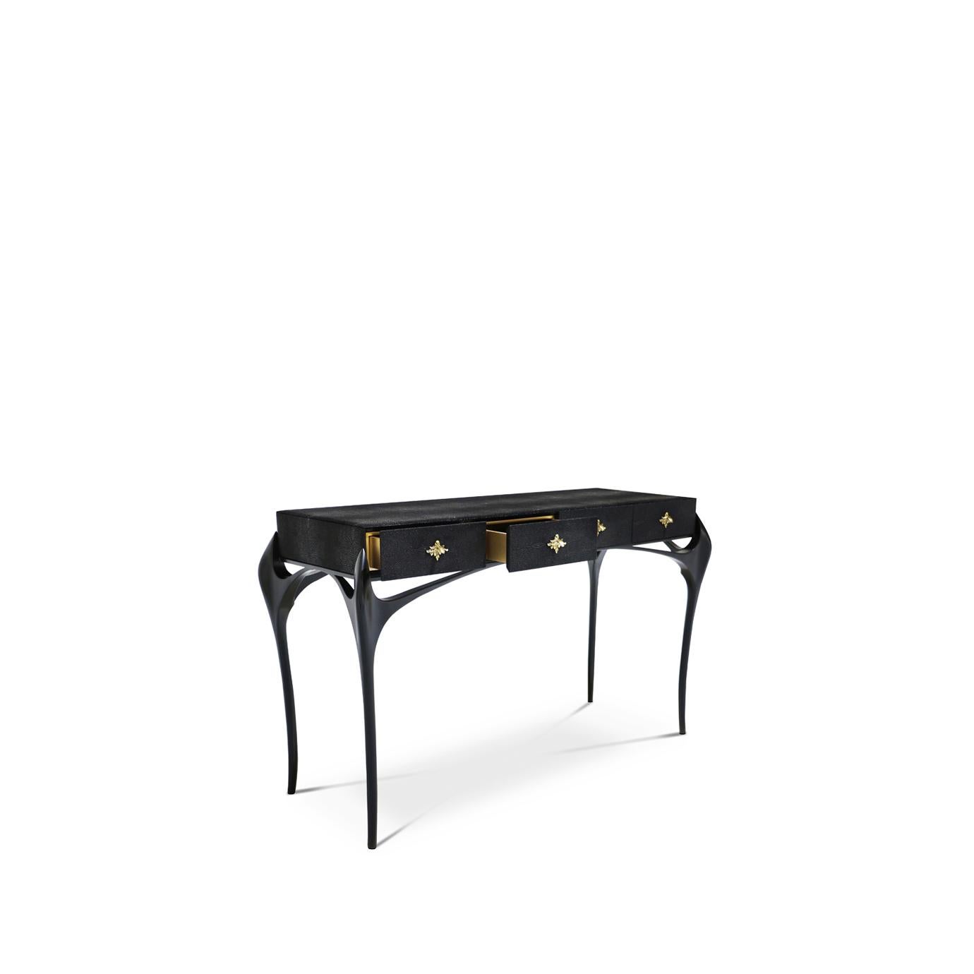 The Temptation console explodes with exoticism and verve with its untamed curves playing side note to a four drawers top, impeccably wrapped in a metallic leather and adorned with an ornate metal pull on each drawer.