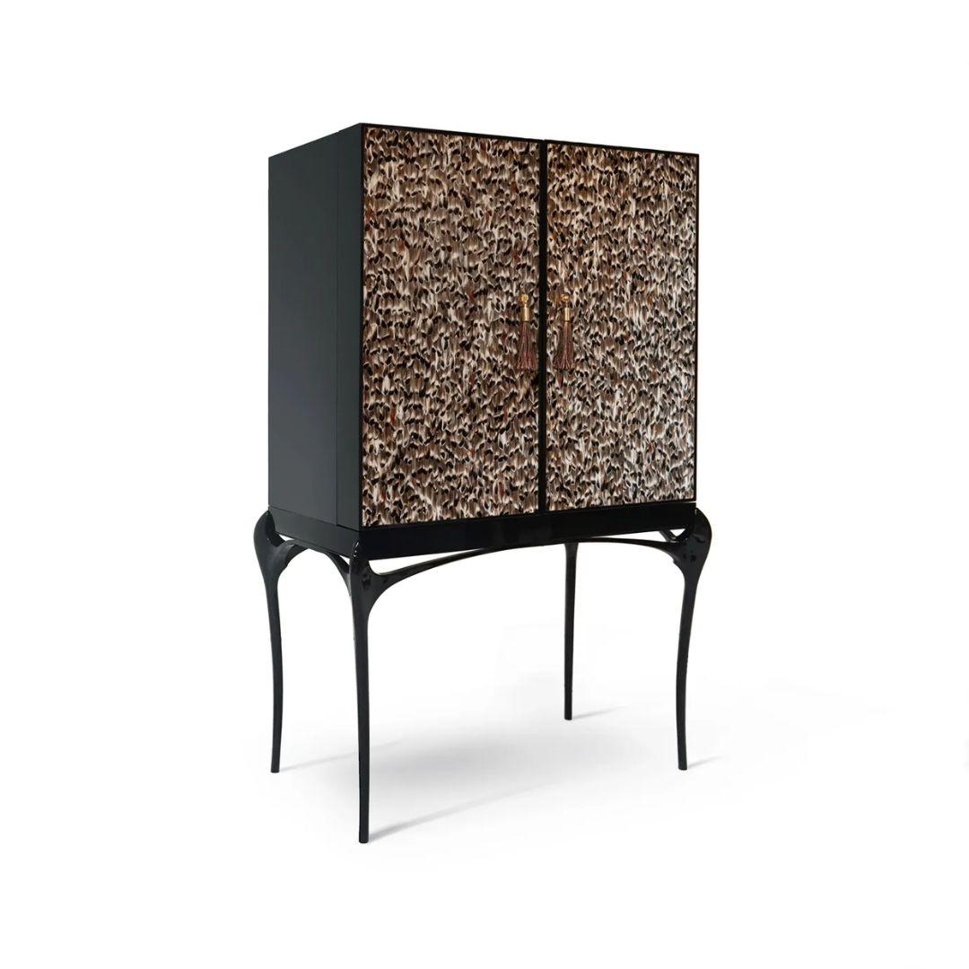 Enticing admirers with its exotic feather doors and sexy curved lacquered legs, the Temptation Bar Cabinet will steal cocktail hour. The chic black and gold interior is perfectly designed to store your wine and cocktail accouterments. Open or closed