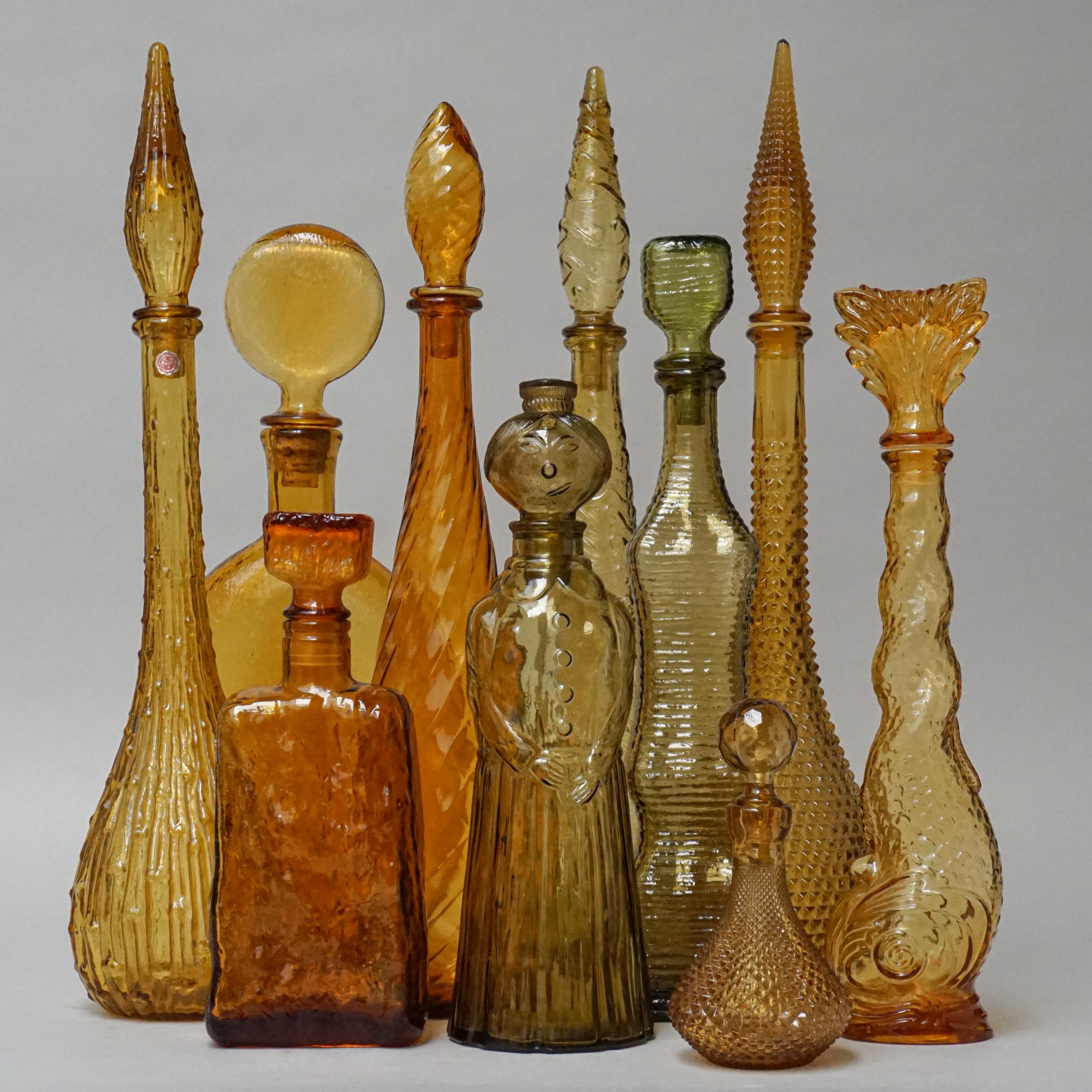 Extraordinary set of ten large vintage glass 'genie bottle' decanters with different shapes in golden amber yellow.
Look at these different shades of 'Golden' colors and all these pretty shapes.
They used to be filled with different kinds of