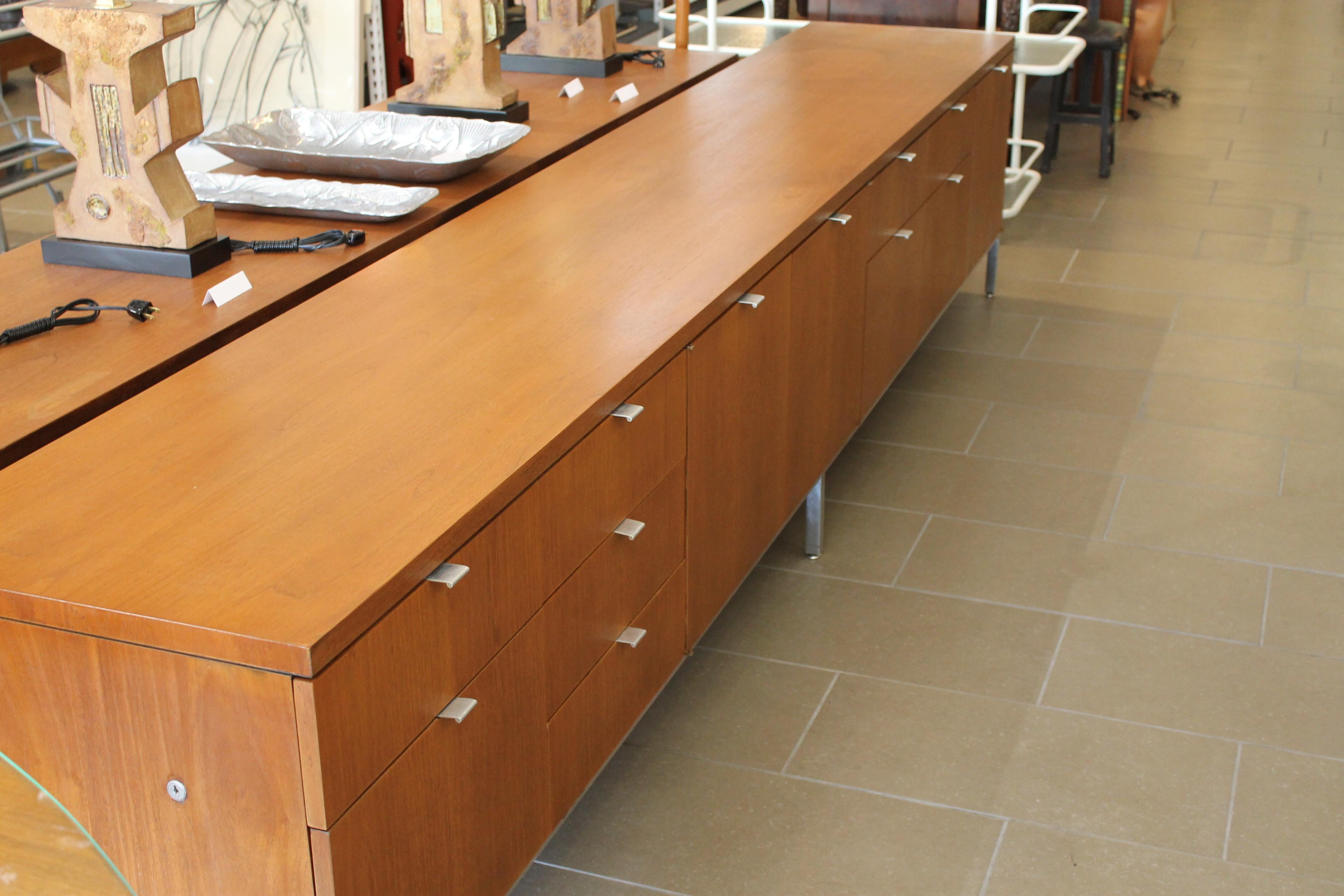 All original 10.5 foot cabinet on steel legs by Domore Office Furniture, Inc. Elkhart, IND., Wichita Falls, Texas. Each drawer has an aluminum pull. There are a total of 12 drawers used for storage. Cabinet measures 126