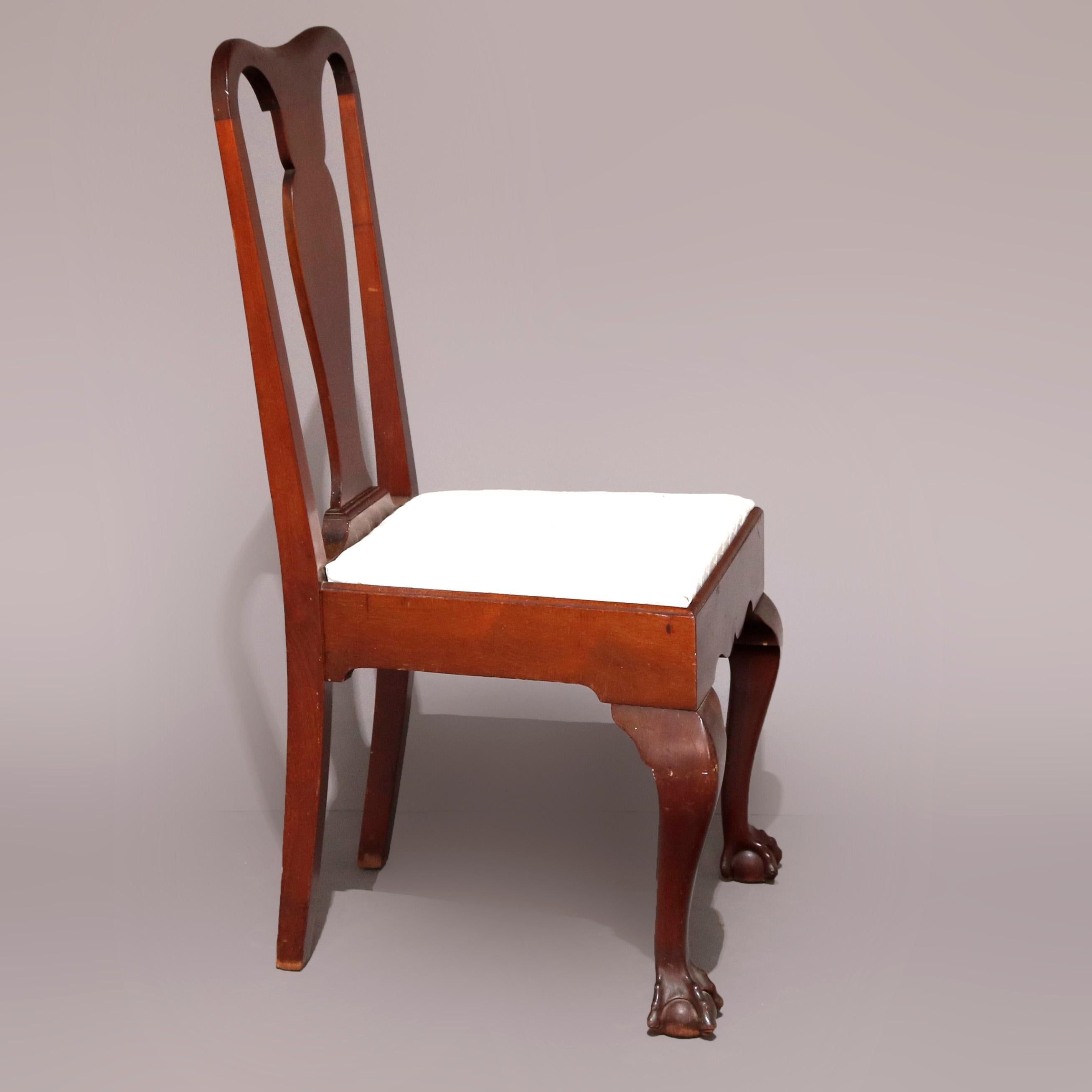 An antique set of 10 American Empire dining chairs offers mahogany construction with slat backs surmounting upholstered seats and raised on cabriole legs terminating in claw and ball feet, circa 1900.

Measures - 40