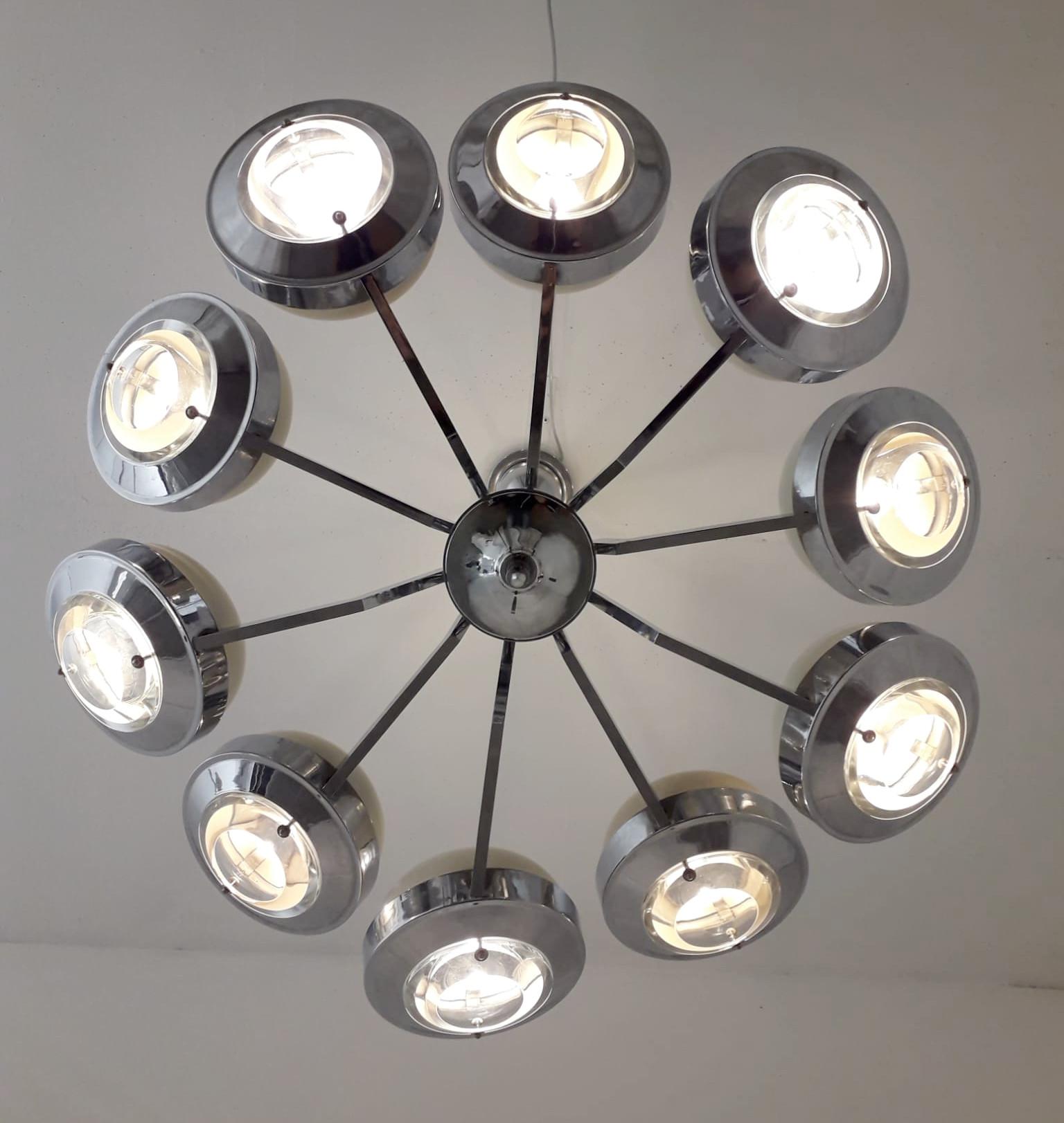Original Italian chandelier of 10 chrome arms with glass lens diffusers and enameled metal shades by Torlasco / Made in Italy circa 1970s
Measures: diameter 31.5 inches, height 32.5 inches including rod and canopy
10 lights / E12 type / max 40W