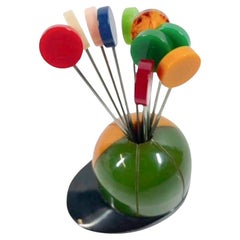 Ten Bakelite Disk Topped Cocktail Picks in a Bakelite Jockey's Cap Stand