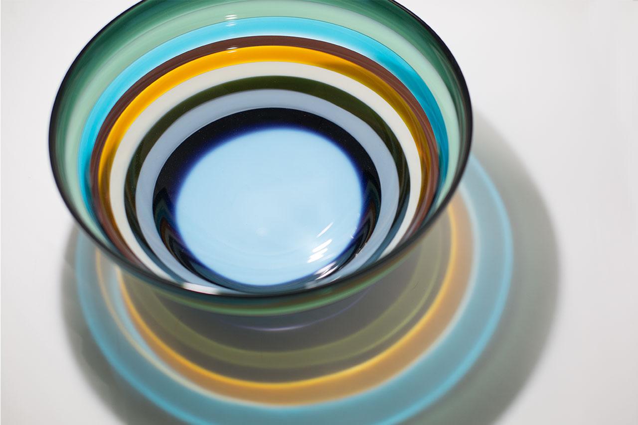 These striking pieces draw inspiration from the rich hues and undulating topography of Southern California. Alternating layers of opaque and transparent colors are applied to clear glass. Overlaps create opportunities for new colors to be formed,