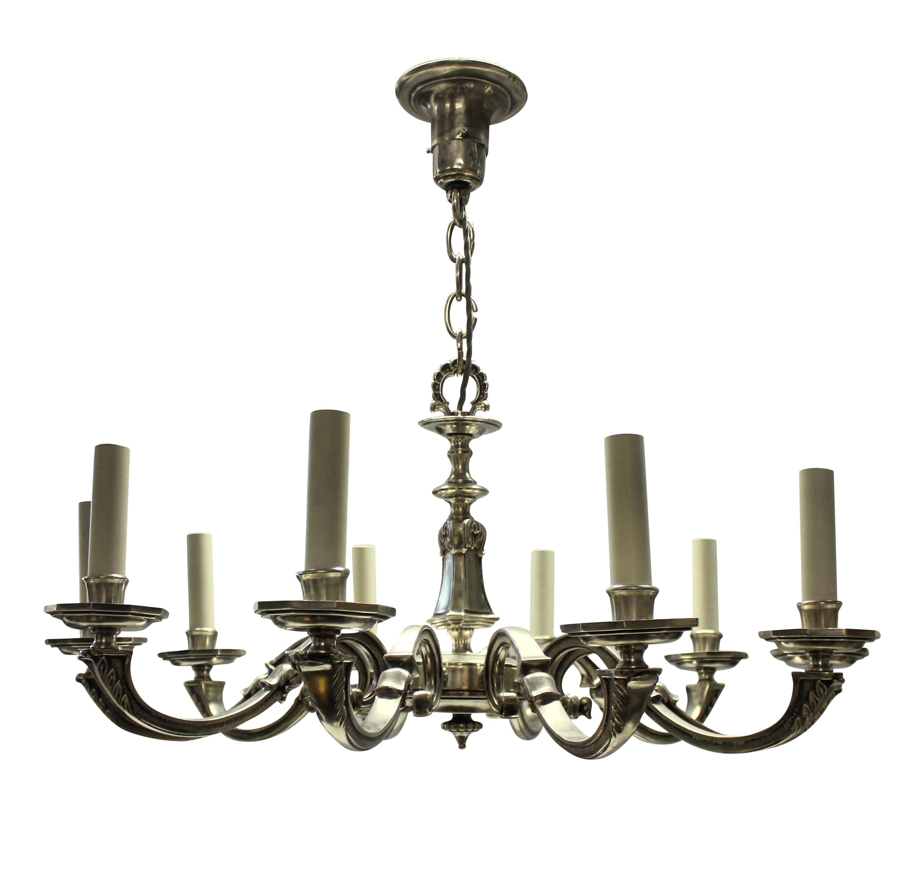 An English neo-classical ten branch silver plated chandelier, which is shallow and suitable for lower ceilings.