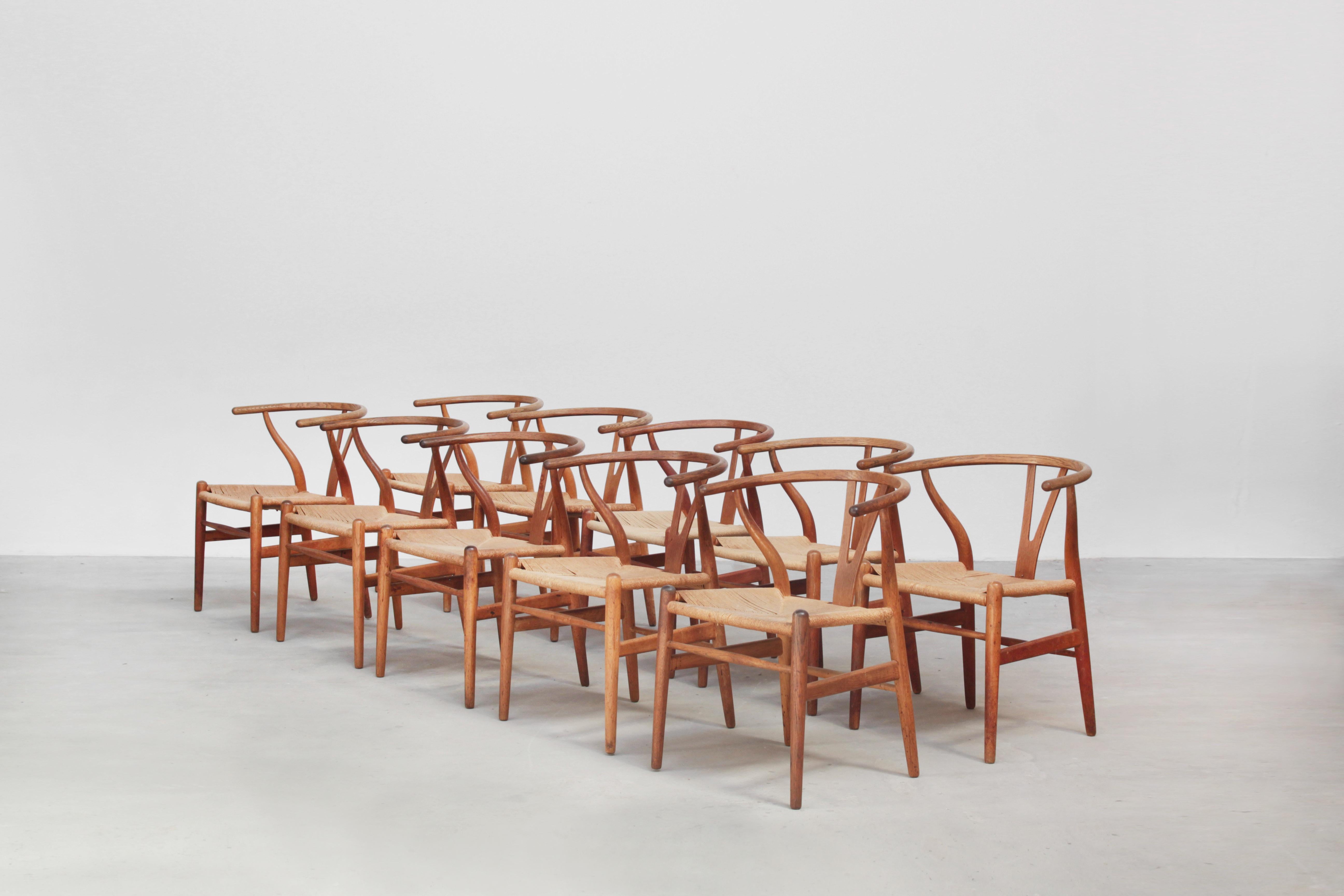 A set of ten beautiful and original wishbone chairs designed by Hans J. Wegner and produced by Carl Hansen in the 1960s in Denmark. All chairs are made out of oak and in a beautiful original condition with signs of usage like little stains, dirt,