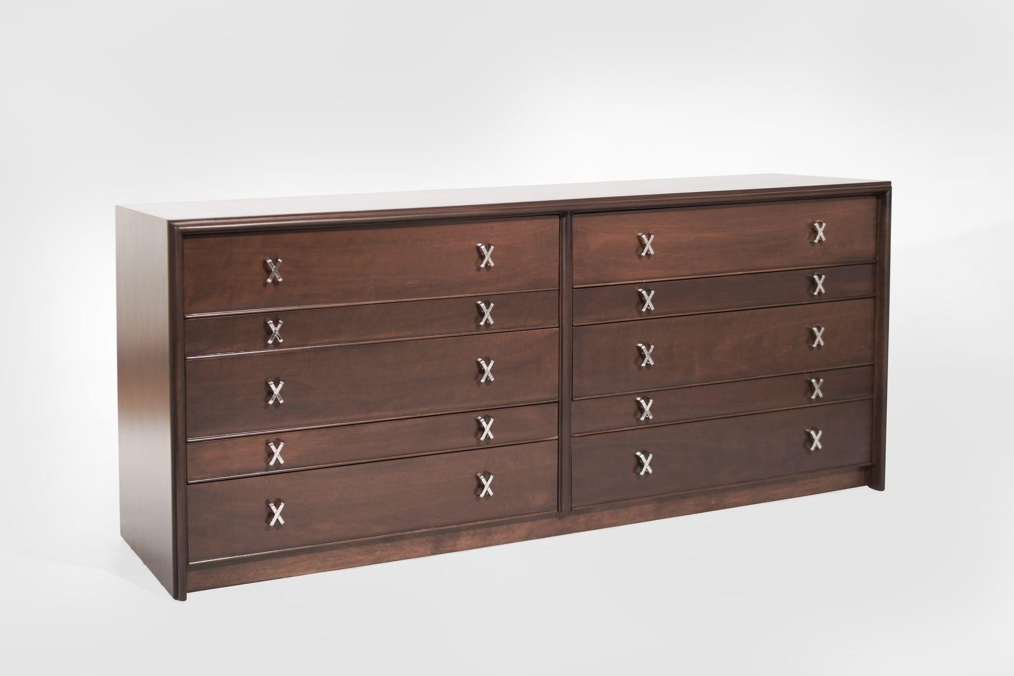A meticulously restored Paul Frankl Dresser from Johnson Furniture, a mid-century masterpiece circa 1950s. This vintage gem, designed by the iconic Paul Frankl, features 10 drawers adorned with X-shaped nickel hardware, meticulously revived to its