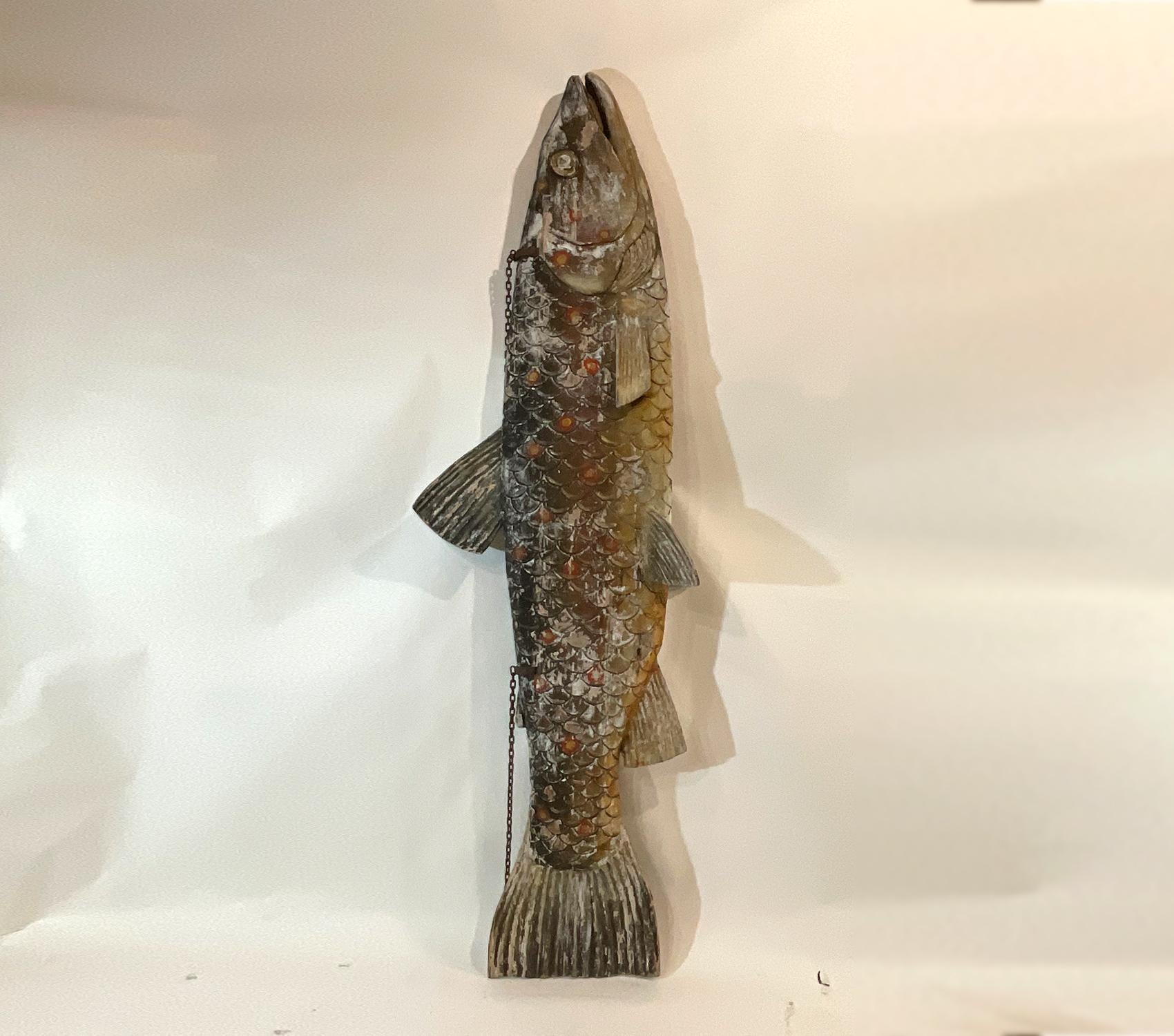 Incredible 115-inch long hanging fish of solid pine in the form of the trade signs that were hung over the fishmongers’ stalls in the Dover England fish market. Distressed painted finish, showing its age, mid twentieth century. Carved in
