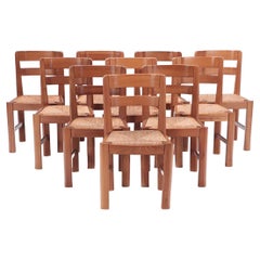 Dix chaises de salle à manger en cerisier français à assise en jonc vers 1960