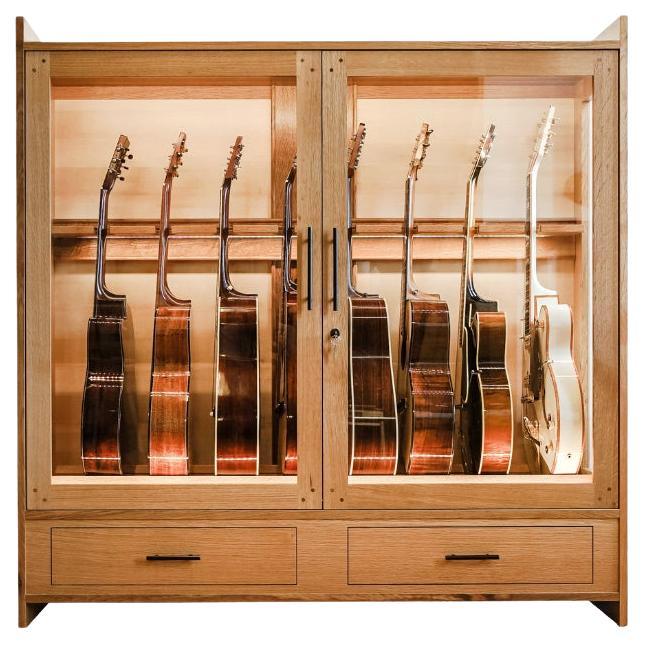 The Guitar Habitat is a handcrafted solid wood cabinet and guitar humidor designed to display acoustic and electric guitars in an easily accessible & elegant ten-guitar display. This humidified guitar display cabinet includes a 1-gallon guitar