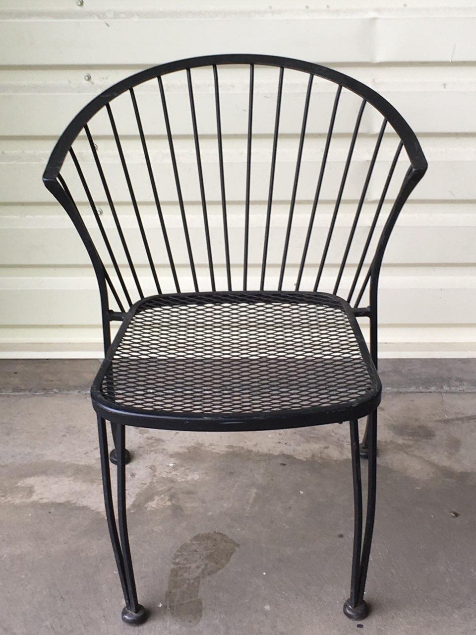 Ten black enameled metal dining height chairs from Woodard's pine crest line have curved and spindle backs, a mesh seat, and four arched legs with round feet.