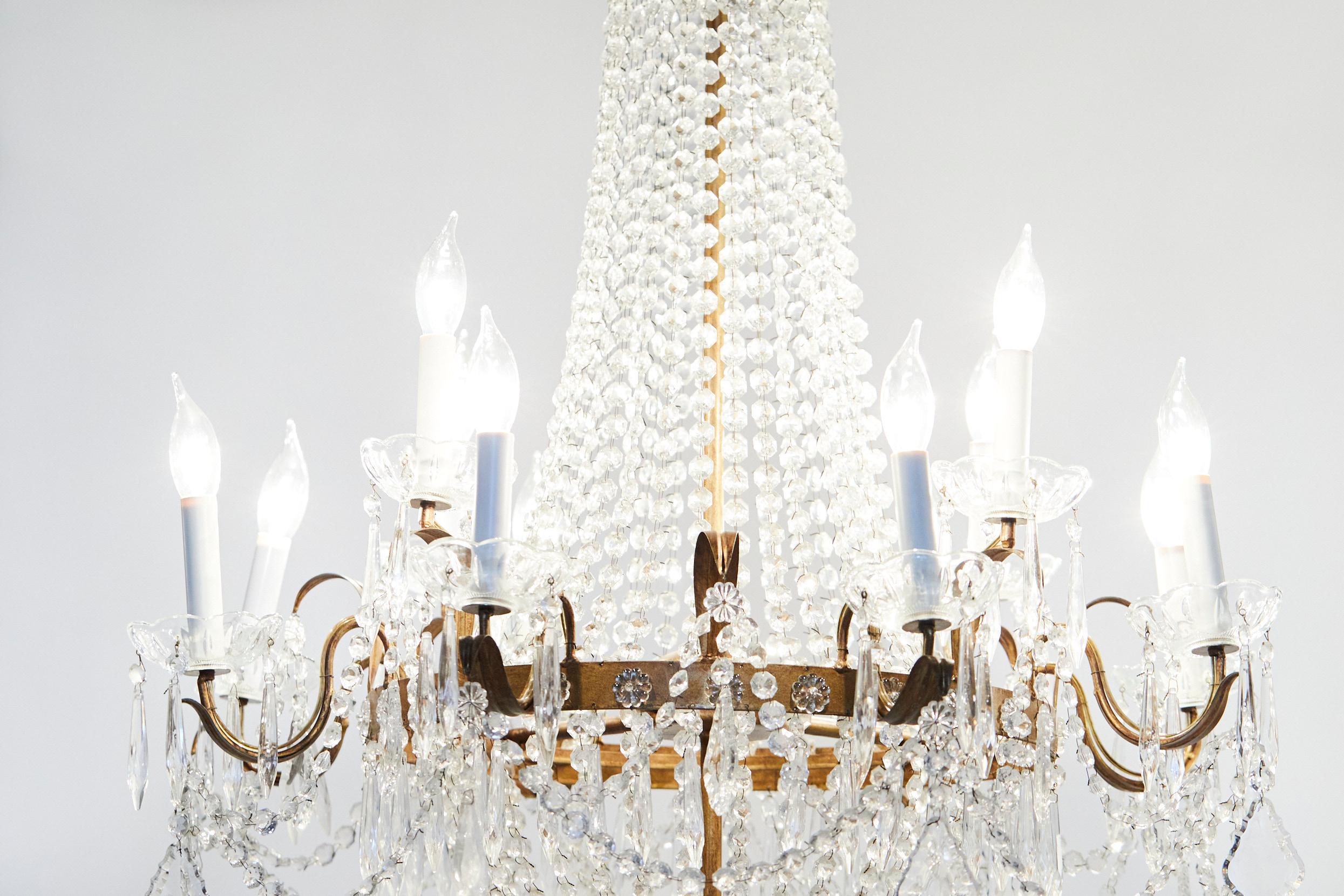 Late 19th century French Empire style tear drop cut crystal / brass frame twelve light hanging chandelier. The chandelier is in great working condition. Rewired for US used. no special light bulb required . The chandelier stands about 44 inches long