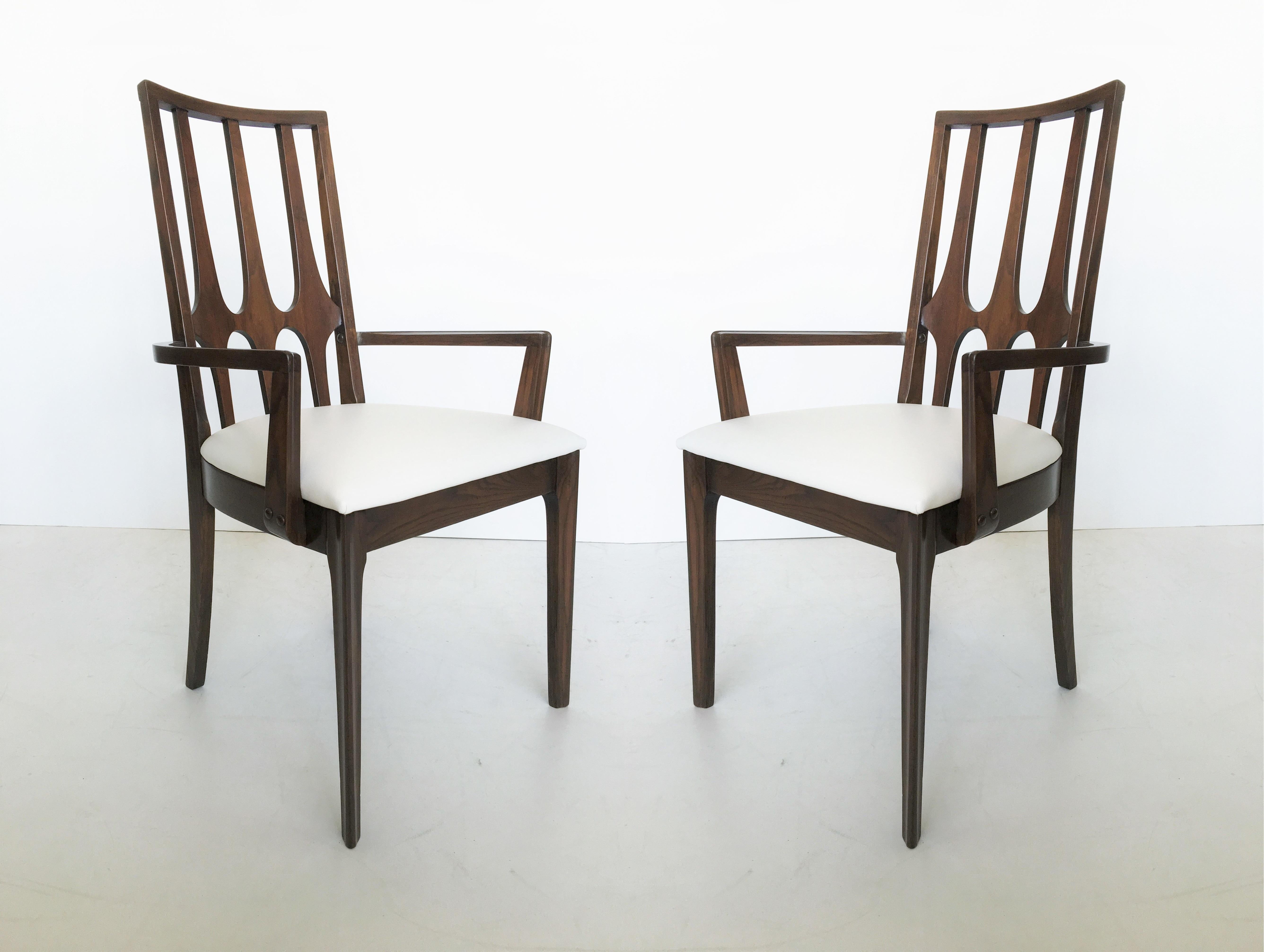 Set of ten vintage walnut dining chairs manufactured by Broyhill for the Brasilia collection, circa early 1960s. It is such a unique design based upon a world-class architect designs for the then new city of Brasila, the 