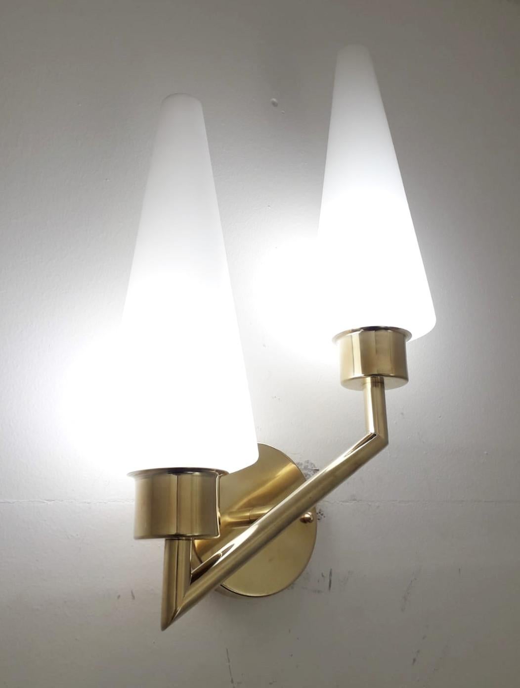 Vintage Italian asymmetrical wall lights with double satin frosted opaline cone shaped glass shades mounted on elegant brass frames by Stilnovo / Made in Italy, circa 1970s
2-light / E14 type / max 40W each
Measures: Height 20 inches, width 11