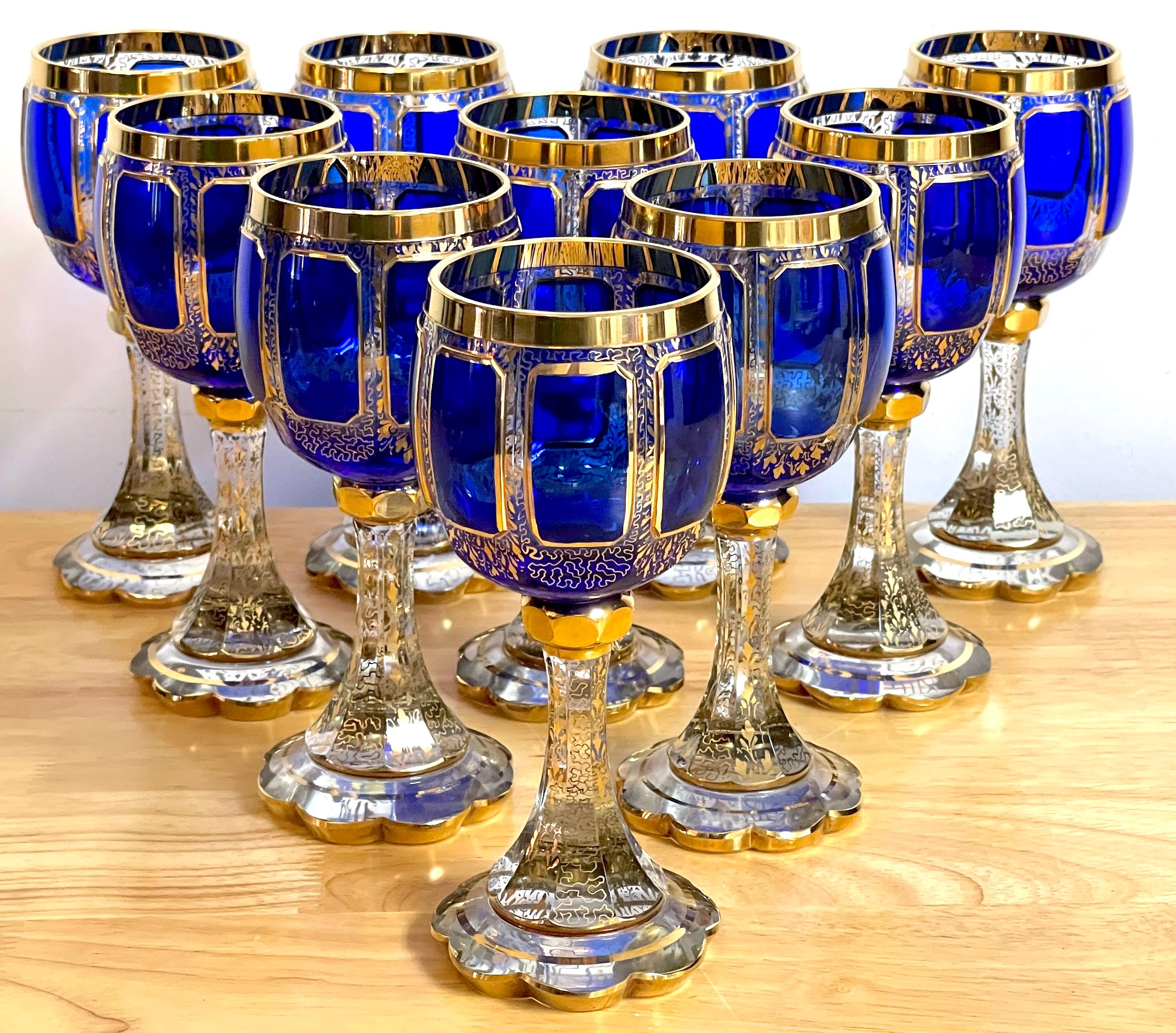 Ten Moser Gilt Enameled Cobalt Paneled Goblets, Each one a chunky goblet with raised eight cobalt panels, with all over intricate gilt enamel. The condition is excellent, no flaws observed, the decoration is bright and intact. There are some