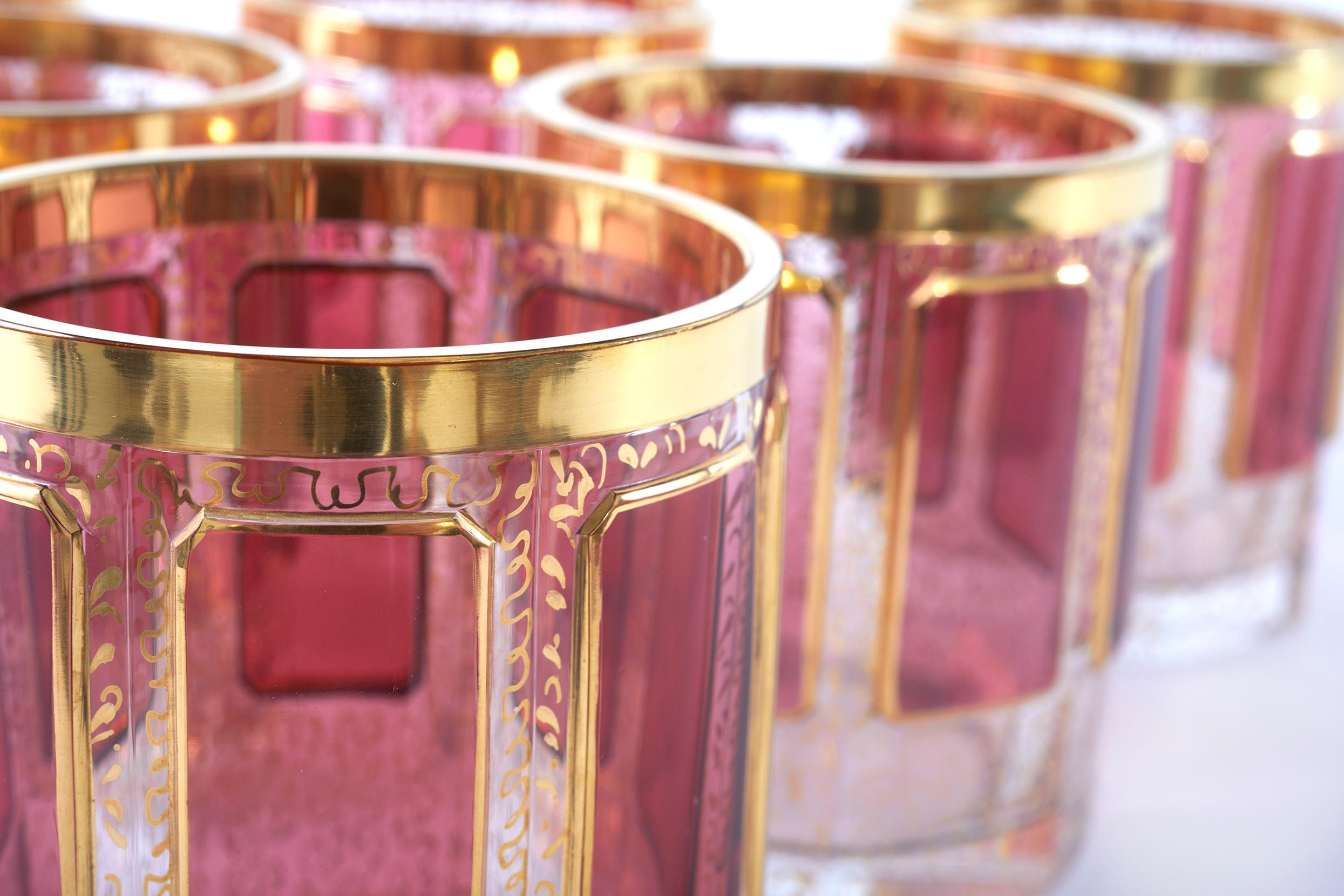Set of Moser gilt enameled pink paneled whiskey / scotch glassware service for six people. Each one is made of a very heavy glass with raised eight pink colored panels, with intricate gilt enamel all over . Each glass is excellent condition .  No
