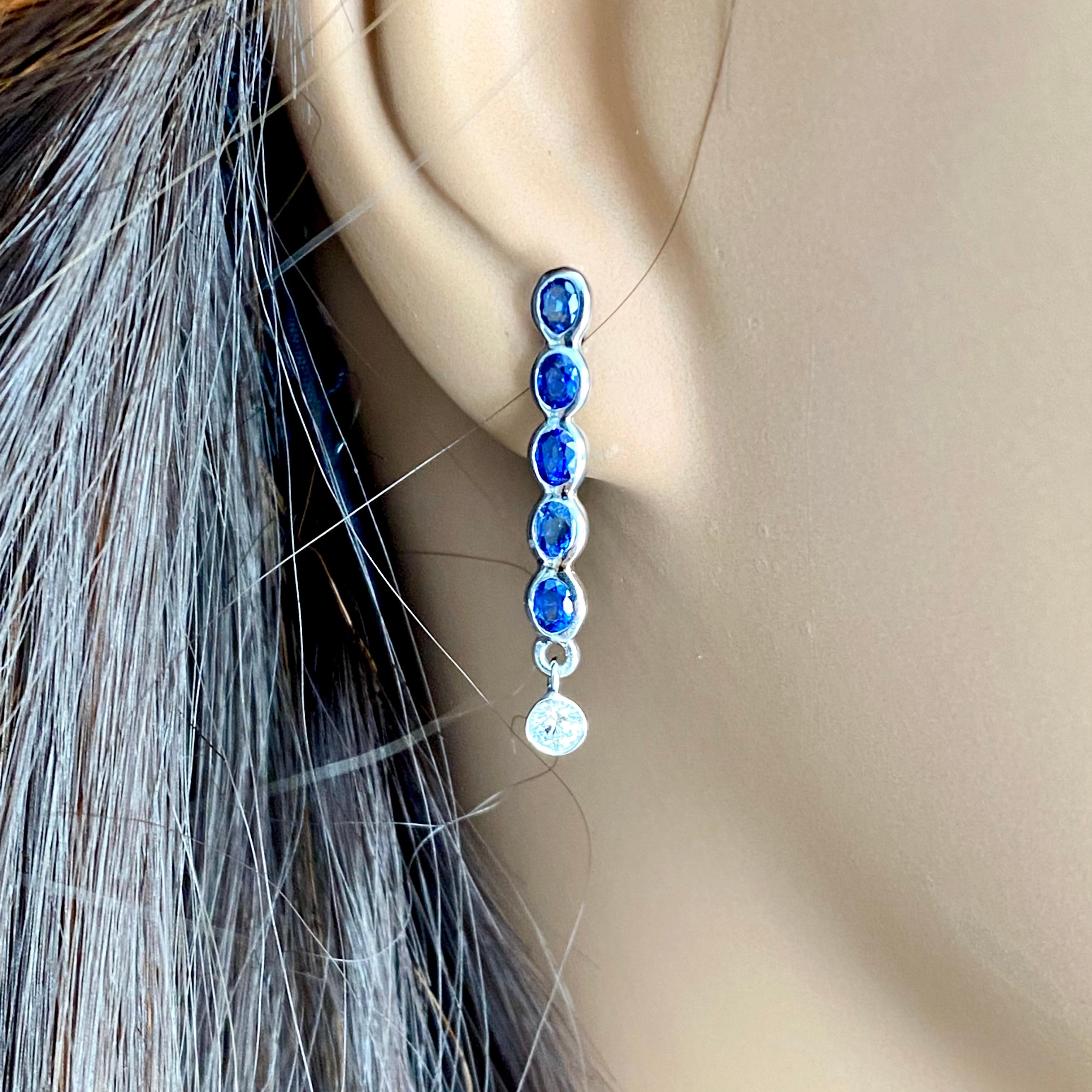 Oval Cut Ten Oval Shaped Sapphire Drop and Two Diamonds Linear White Gold Drop Earrings