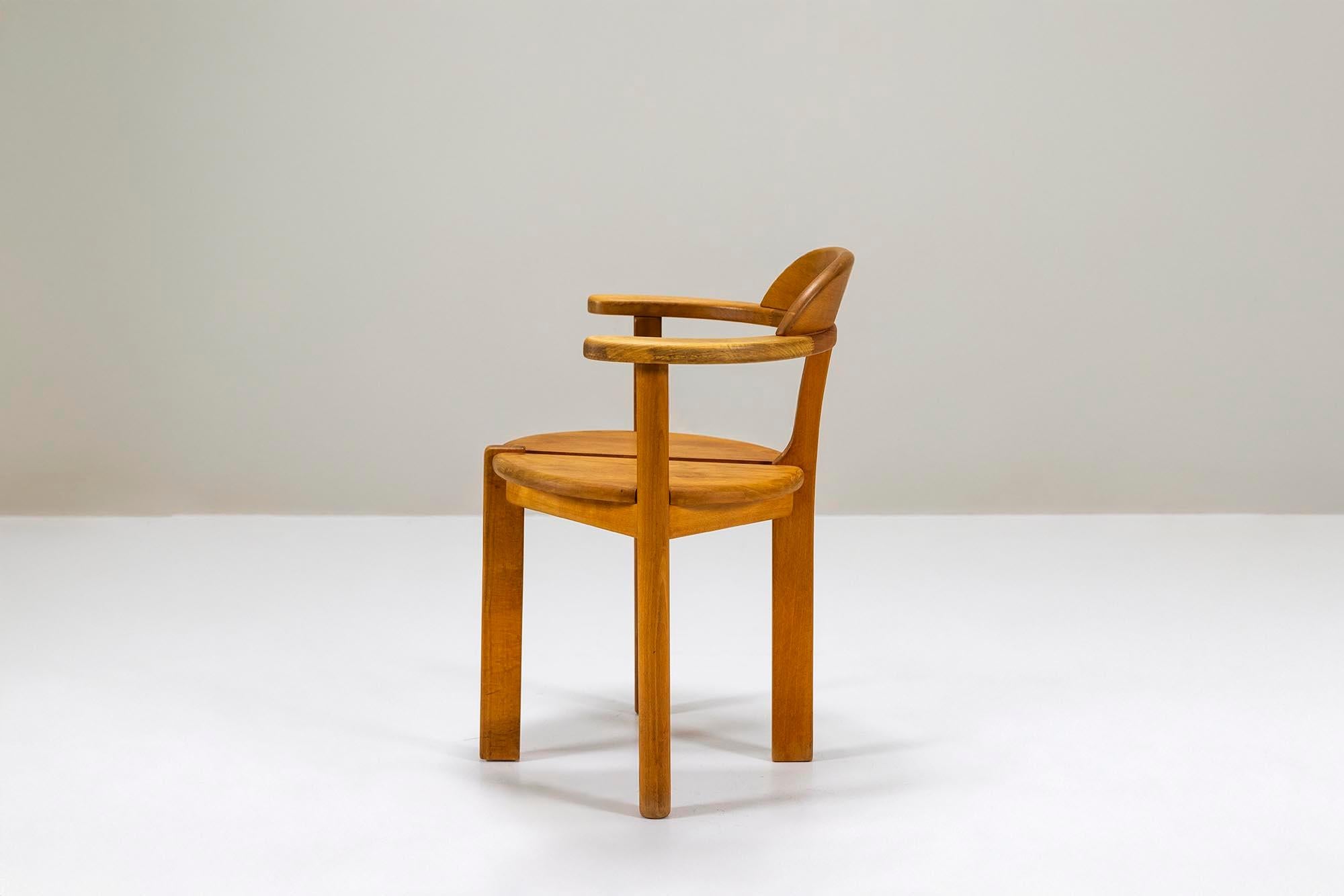A set of ten pinewood chairs with a sculptural and robust presence. Designed in a style reminiscent of Rainer Daumiller and Erwin Berghammer, these chairs embrace simplicity and functionality. Crafted with precision, they exude a warm natural
