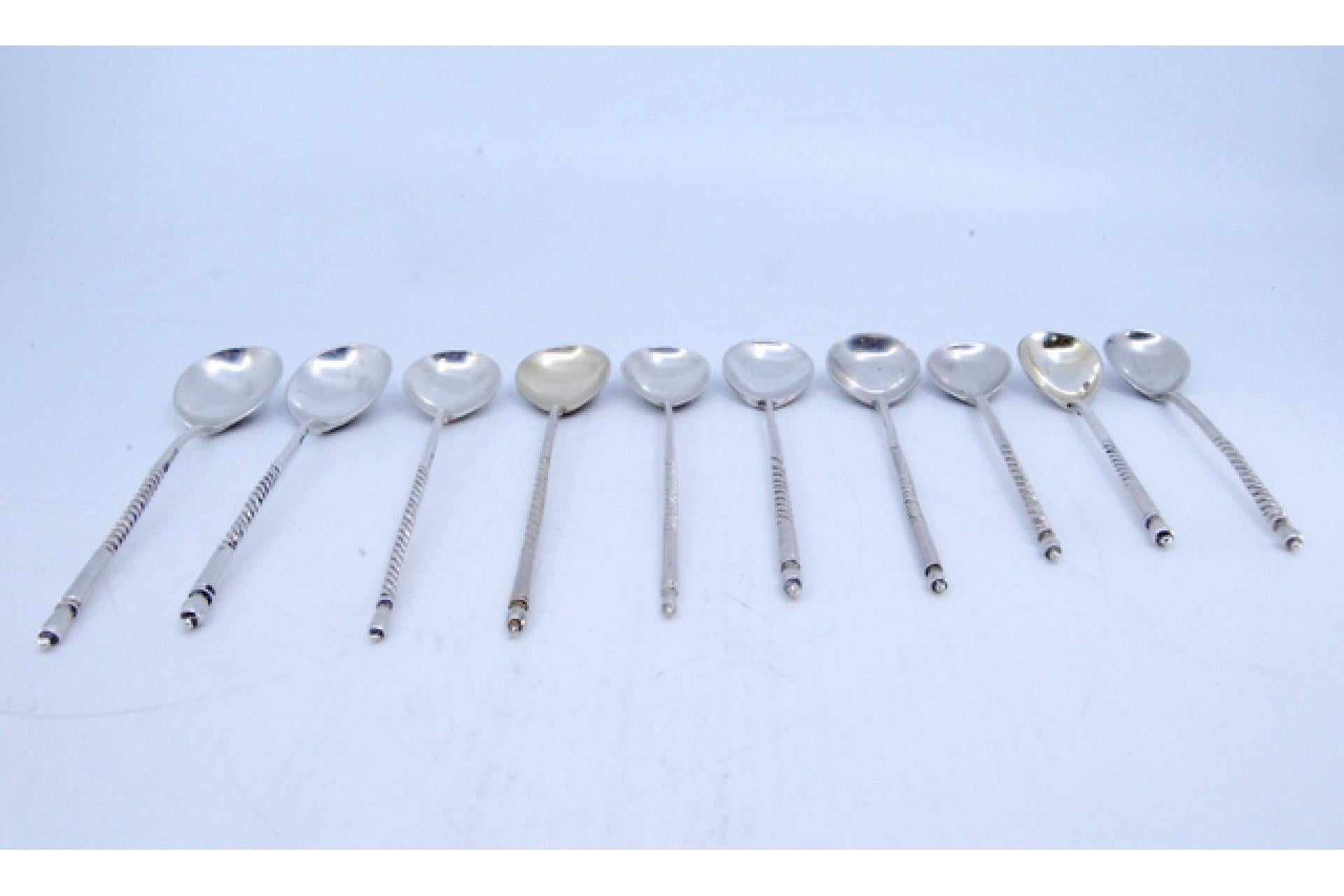 European Ten silver dessert spoons with engraved shells and twisted Russian handles For Sale