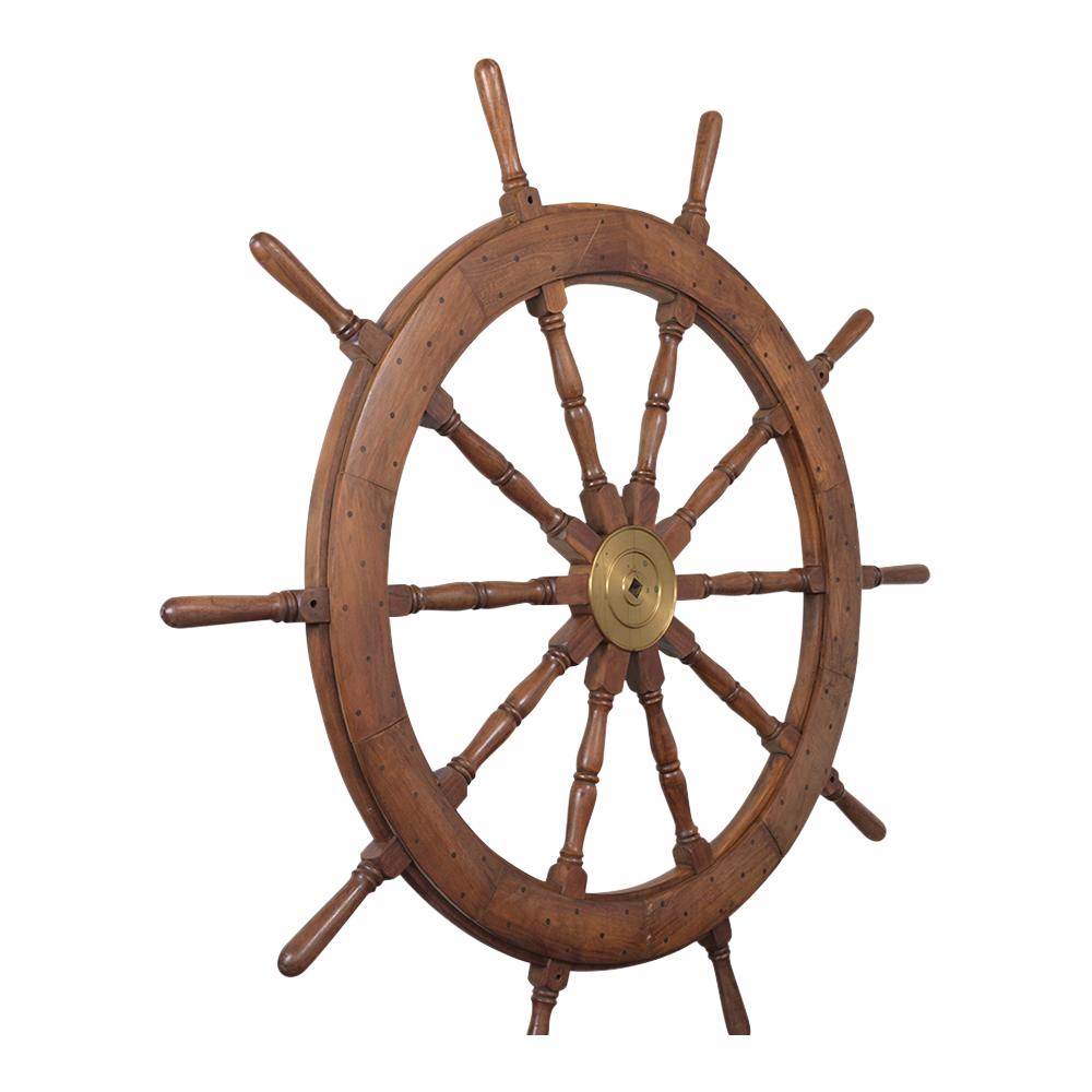 This large handcrafted yacht wheel is in great condition, comes with ten spokes and a large polished brass hub. The wheel also features an alternating wood inlay pattern and is ready to be used or displayed for years to come.