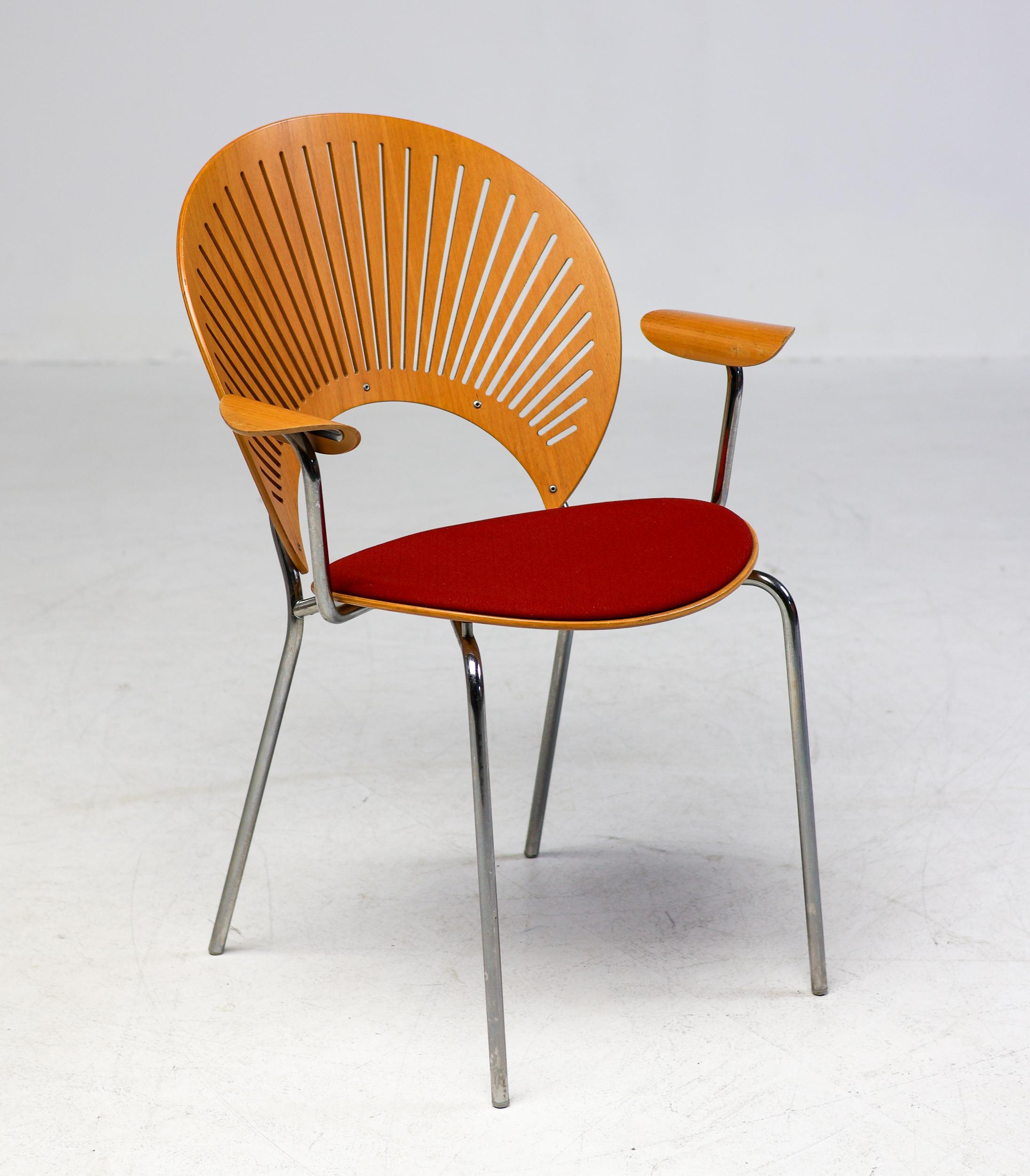 Very rare teak Trinidad dining chairs with arms by Nanna Ditzel for Fredericia Stolefabrik Denmark, circa 1995.  The seat cushions in red fabric are in good condition and are easily reupholstered in your choice of fabric or leather upon request.