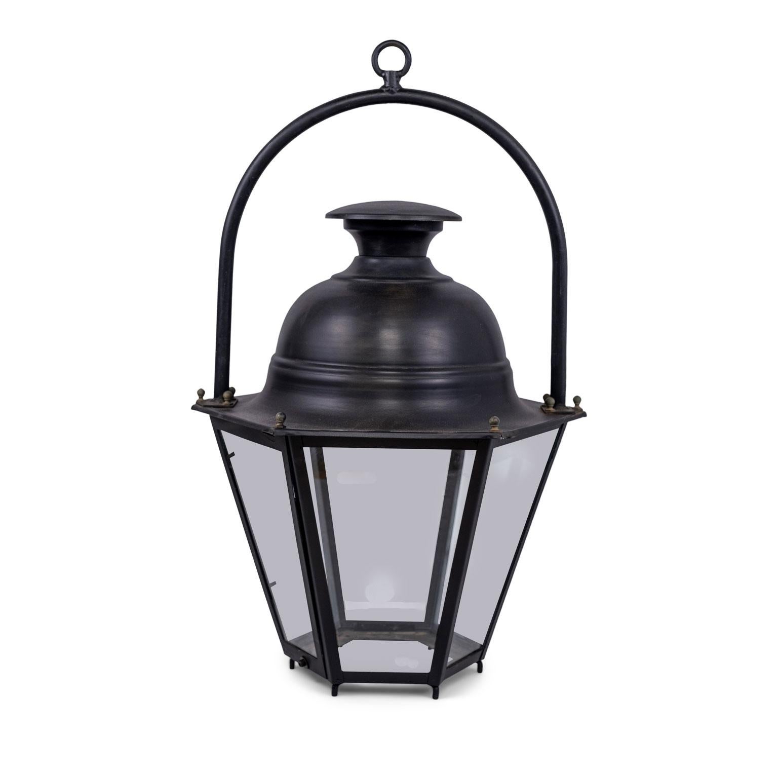 Six vintage black-painted hexagonal street lanterns from the South of France. Sold unwired, but may be wired for electricity or fitted for use with gas for an additional cost. Lanterns sold individually and priced $3,800 each.