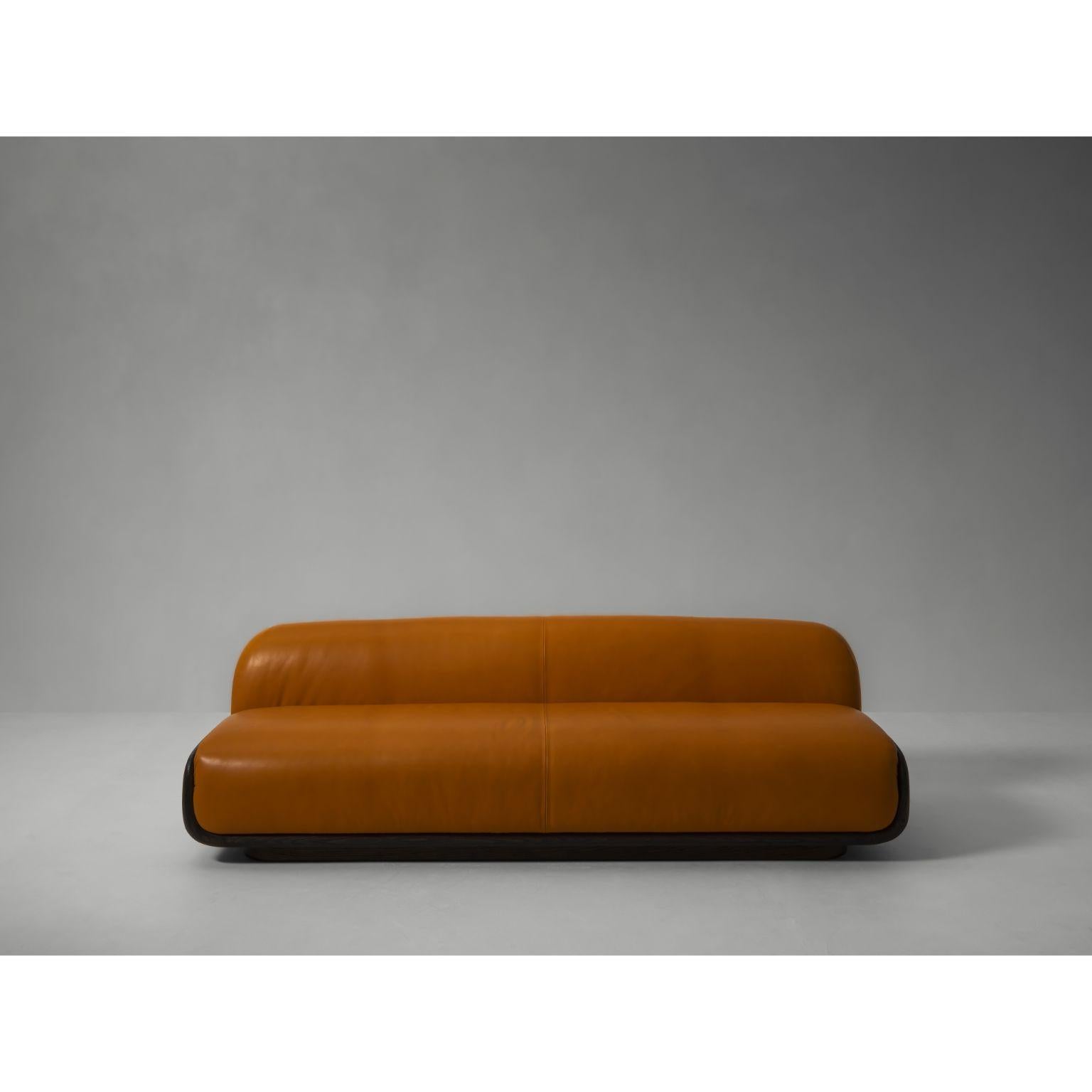 Tenere Sofa by Van Rossum
Dimensions: D 290 x W 80 x H 68 cm
Materials: Oak, Upholstery, Leather

A generous three-seat sofa with a wooden frame and pillowy, organically shaped upholstered cushions. Available in French oak, and with your preferred
