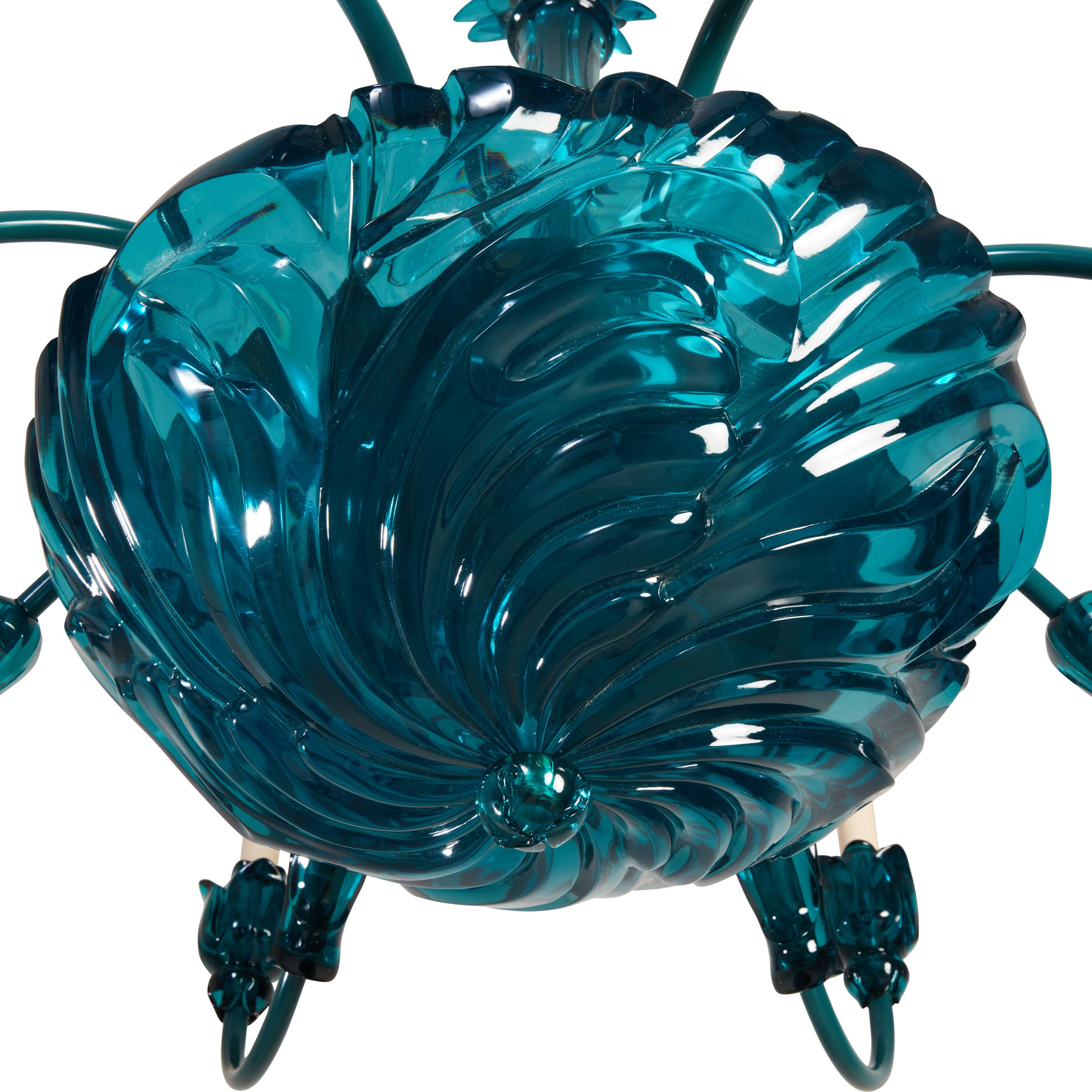 A single-tiered 8-light chandelier with shell formed dish, secured on underside by over-sized finial, the dish issuing candle-arms with applied leaf-shaped ornaments and lotus-form bobeches. The clear transparent teal resin and elements secured to