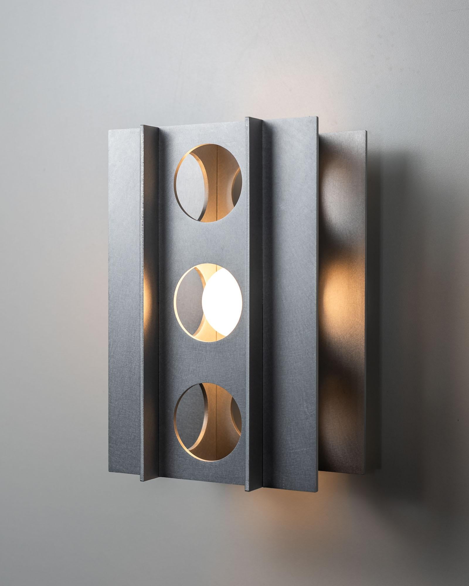 Tenfold 3T Wall Sconce in Satin Aluminum by Luft Tanaka Studio

Brutalism meets glam. Wall light inspired by brutalist design and Op Art composed of interlocking metal panels. 

Made to order. Assembled and shipped from Brooklyn, NY.

Typical lead