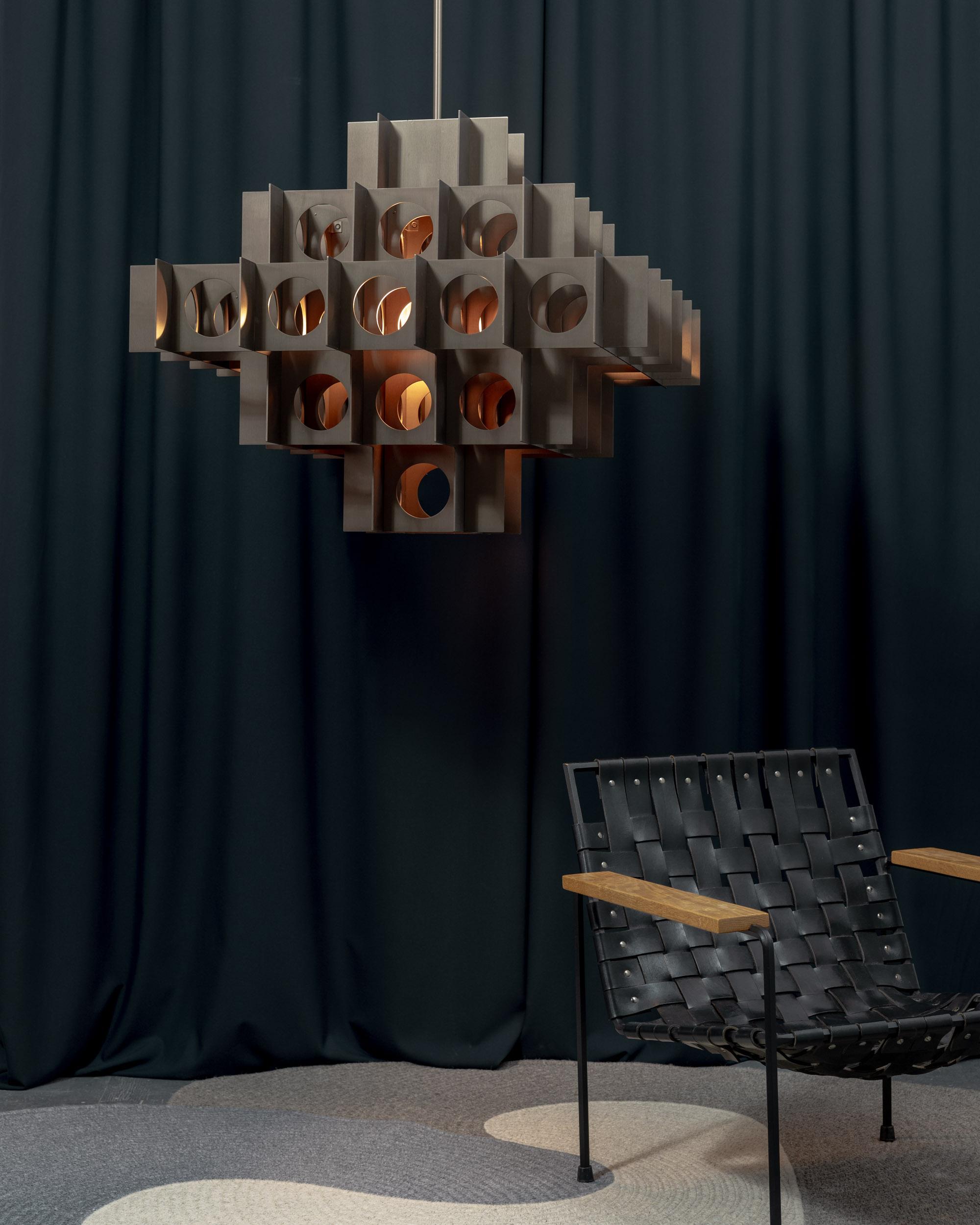 TENFOLD CHANDELIER 5 TIER 24inch in Brushed Bronze by Luft Tanaka Studio

Brutalism meets glam. Inspired by Brutalist architecture and Op Art, the Tenfold Series features interlocking perforated metal panels that create a dramatic visual effect. The