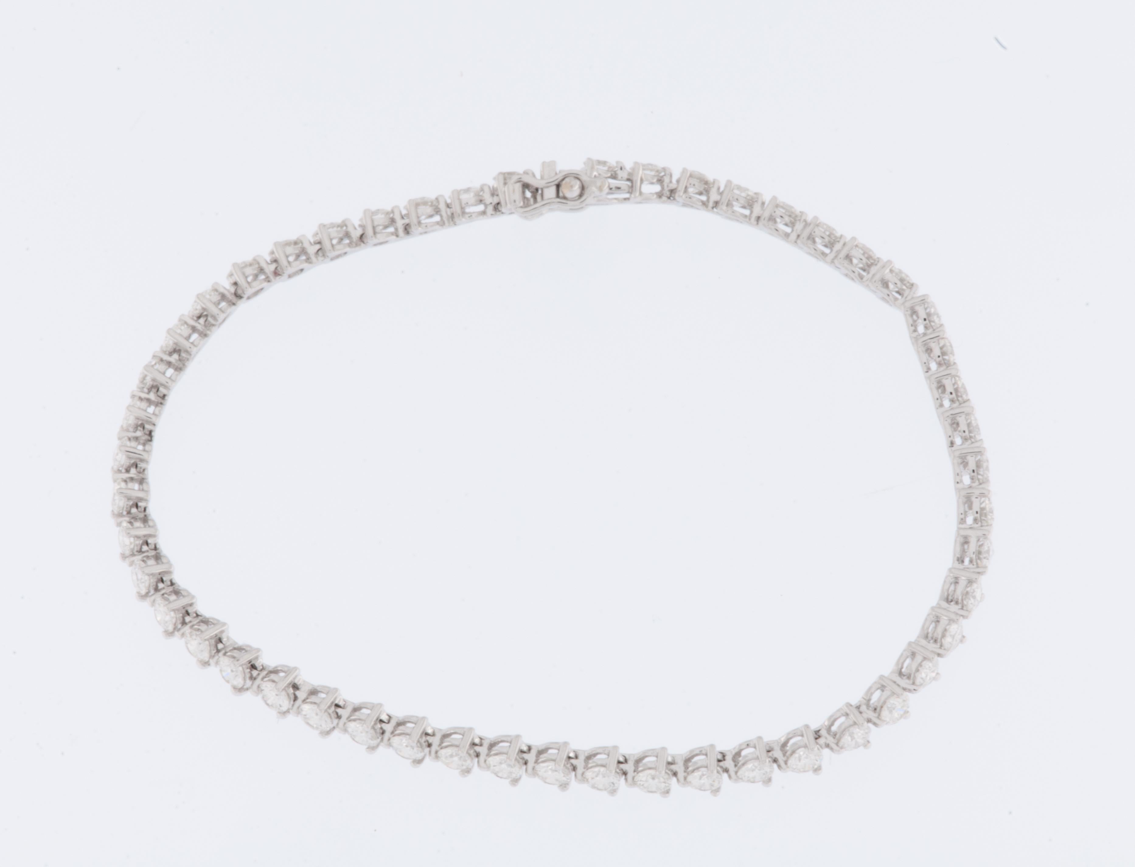 The Tennis Bracelet in 18-karat White Gold with 50 Diamonds is an exquisite and timeless piece of jewelry that radiates sophistication and elegance. This bracelet is designed to showcase a classic and versatile style, making it a perfect accessory